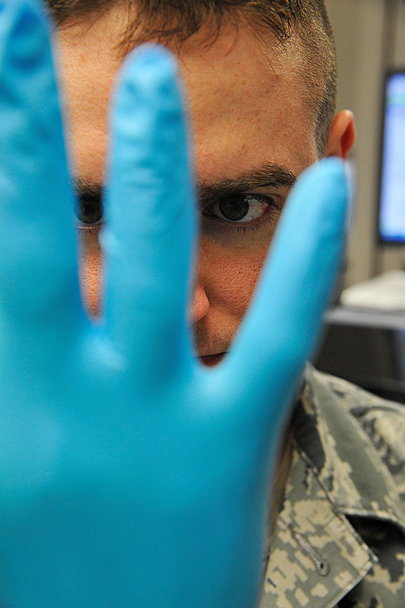 U.S. Air Force Staff Sgt. Nathan Knox, 509th Medical Support Squadron medical lab technician, prepares to examine blood samples at Whiteman Air Force Base, Mo., March 18, 2015. Gloves are used as a form of personal protective equipment to avoid contact with disease, infections and bacteria. (U.S. Air Force photo by Senior Airman Keenan Berry/Released)