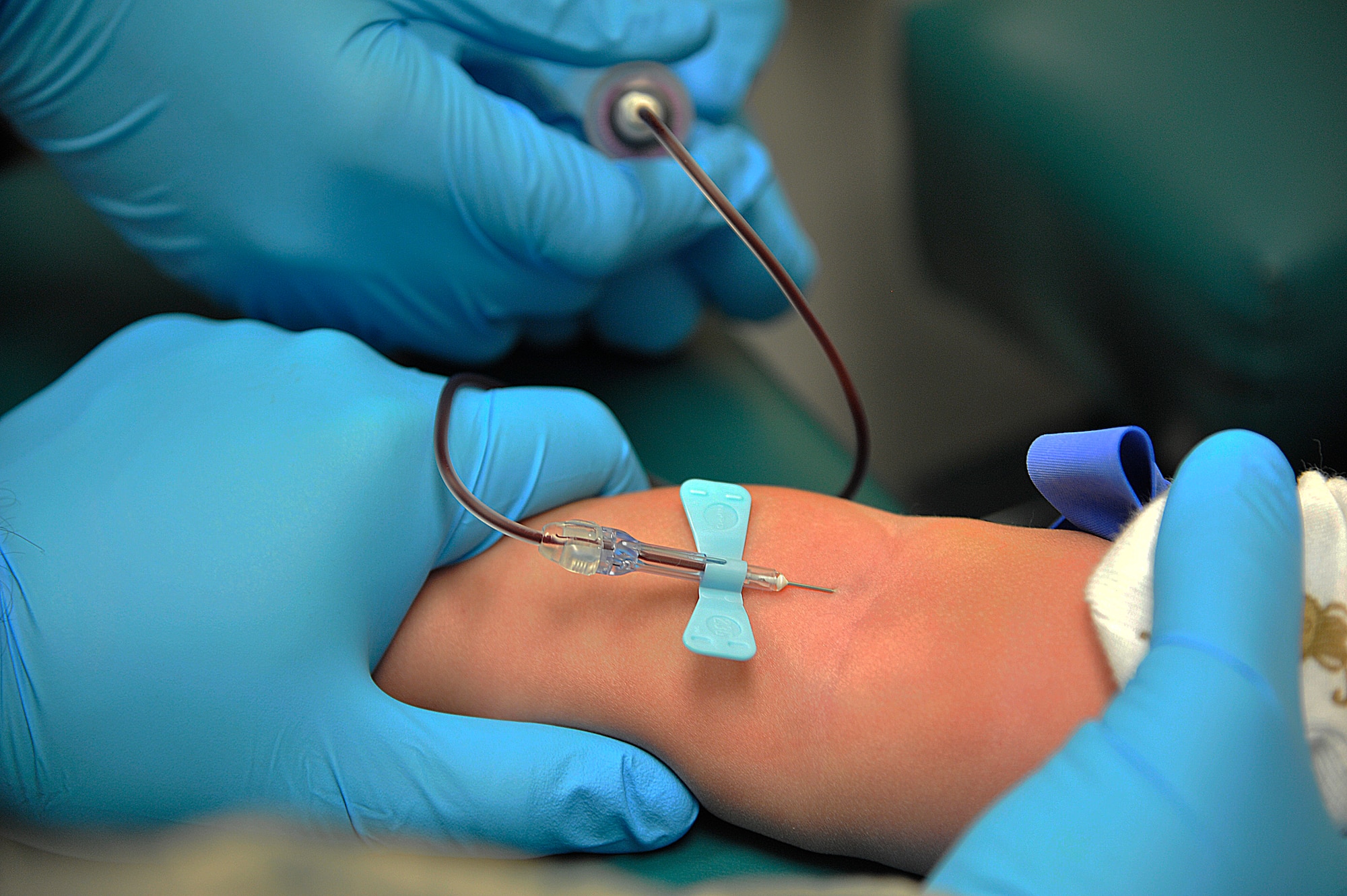 Nicole Davis, 509th Medical Support Squadron phlebotomist, performs a venipuncture procedure on a patient at Whiteman Air Force Base, Mo., March 18, 2015. The blood is drawn to be tested for any health problems or ailments. (U.S. Air Force photo by Senior Airman Keenan Berry/Released)