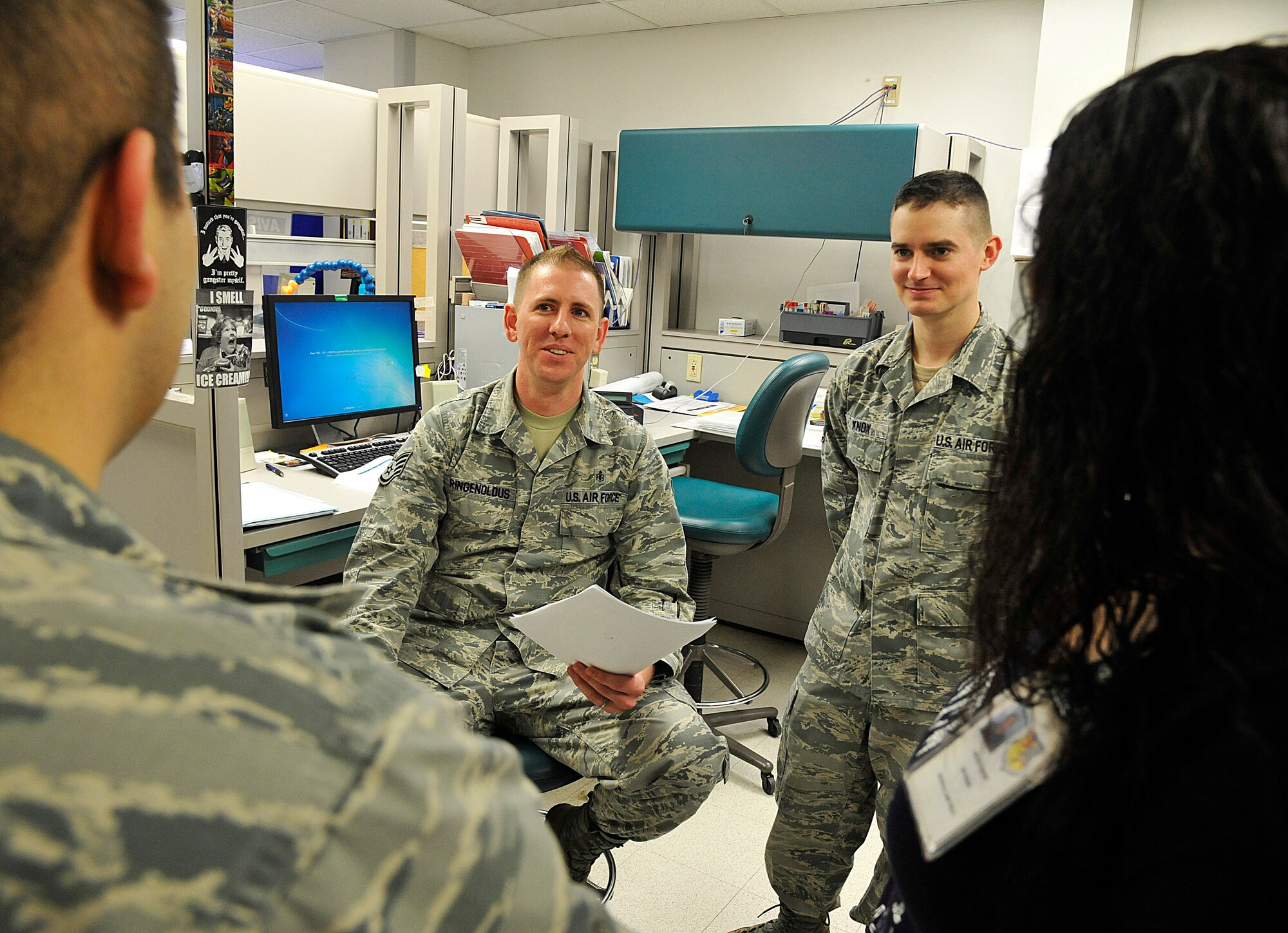 U.S. Air Force Staff Sgt. Jon Rigenoldus, 509th Medical Support Squadron medical lab technician, discusses afternoon handoff at Whiteman Air Force Base, Mo., March 18, 2015. This is done to ensure successful turnover of information to maintain steady production. (U.S. Air Force photo by Senior Airman Keenan Berry/Released)