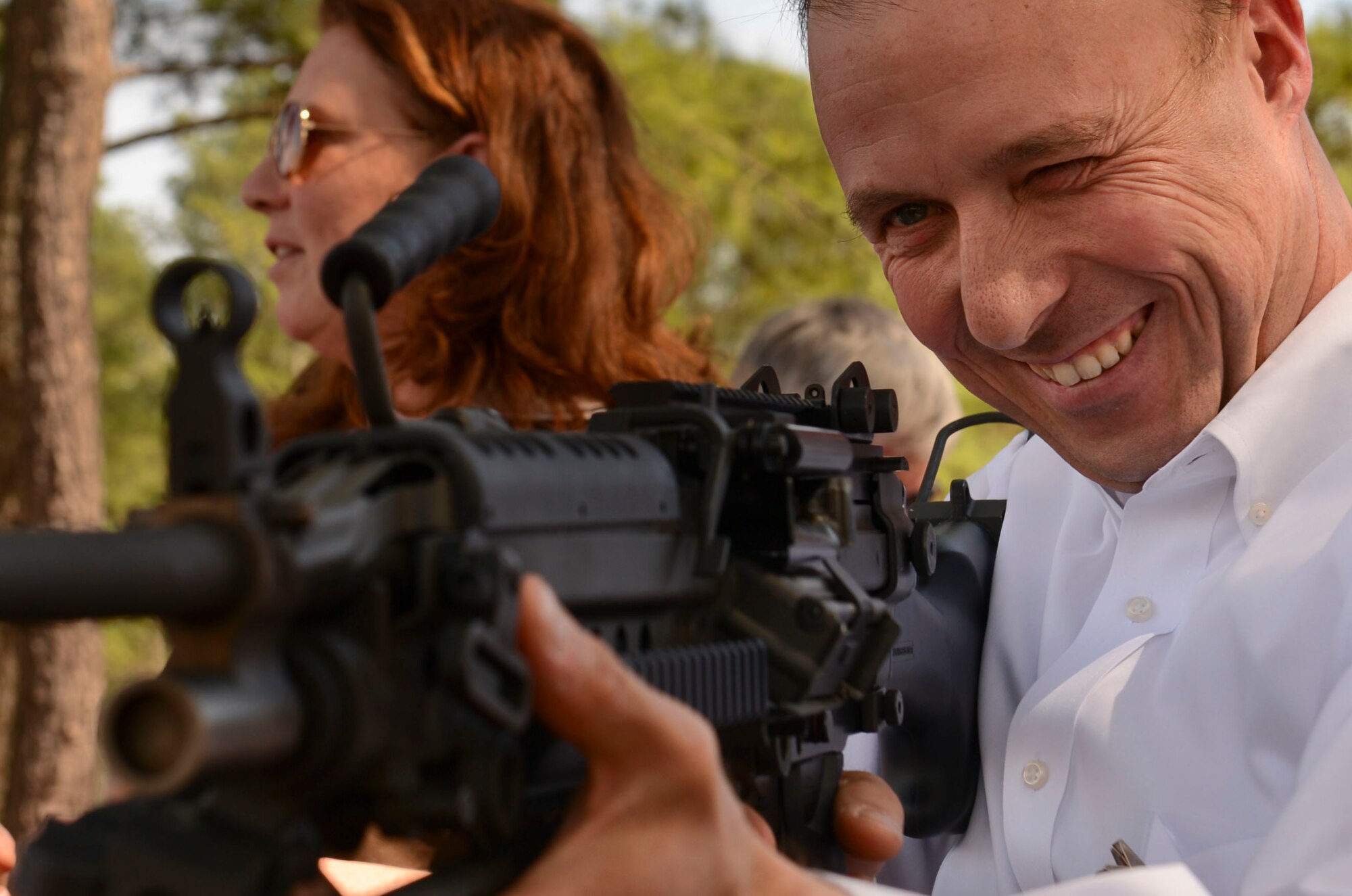 Mark Mossell, honorary commander for the 20th Operations Group deputy commander with First Citizens Bank, looks through the sight of an M-249 automatic rifle at Shaw Air Force Base, S.C., March 17, 2015. During the annual honorary commanders tour, 20th Security Forces Squadron Combat Arms instructors displayed unarmed weaponry to show the community members some of the firearms Shaw AFB uses. (U.S. Air Force photo by Senior Airman Tabatha Zarrella/Released)