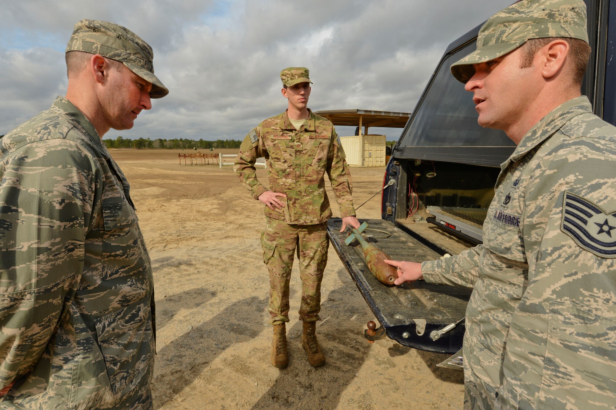 U.S. Air Force Tech. Sgt. William Senecal, 20th Civil Engineer Squadron explosive ordinance disposal operations NCO in charge, speaks to Col. Stephen Jost, 20th Fighter Wing commander about the munitions used at Poinsett Electronic Combat Range, Sumter, S.C., Mar. 5, 2015. None of the munitions used at Poinsett are live, after dropped during training, they are disposed of by EOD. (U.S. Air Force photo by Senior Airman Tabatha Zarrella/Released)