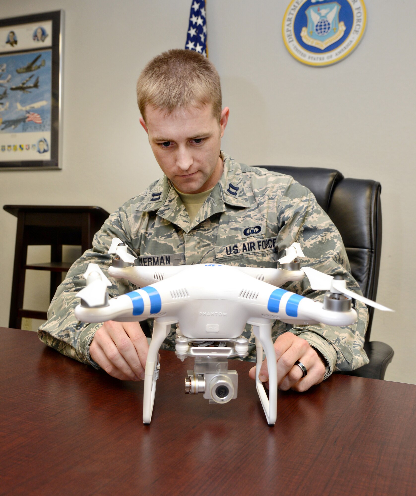 Capt. Tommy Ackerman, Airfield Operations Flight commander for the 72nd Operations Support Squadron, shows a drone unmanned aerial vehicle, with was recently confiscated by the 72nd Security Forces Squadron after it was flown on Tinker. (Air Force photo by Kelly White)