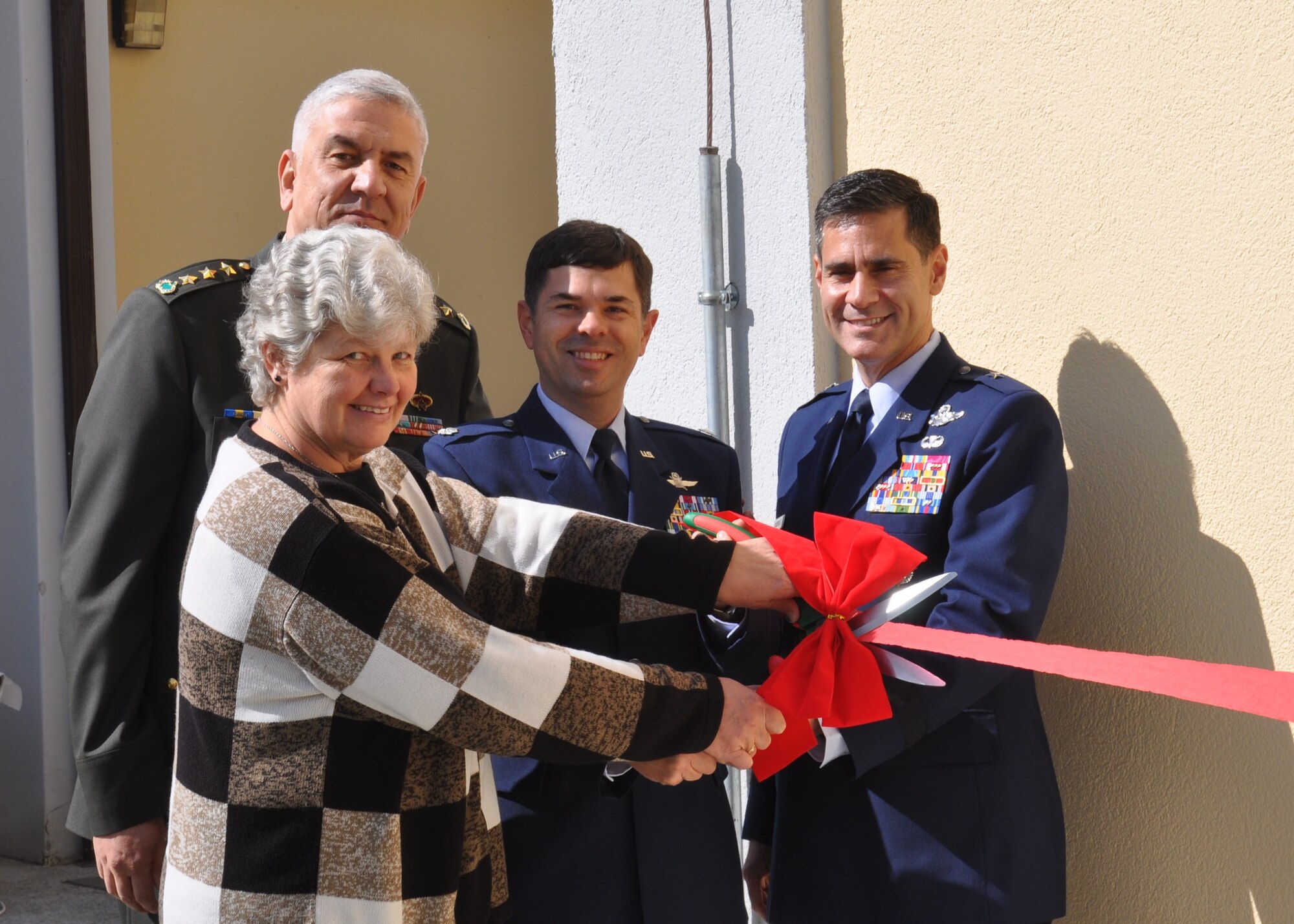 Representatives of the U.S. Air Force, Turkish Air Force and U.S. Army Corps of Engineers prepare to cut the ribbon during the grand opening of the new administrative building March 26, 2015, at the Ankara Support Facility in Turkey.  This new building, number 2621, is located adjacent to the Base Exchange. (U.S. Air Force photo by Capt. Laura Balch/Released)
