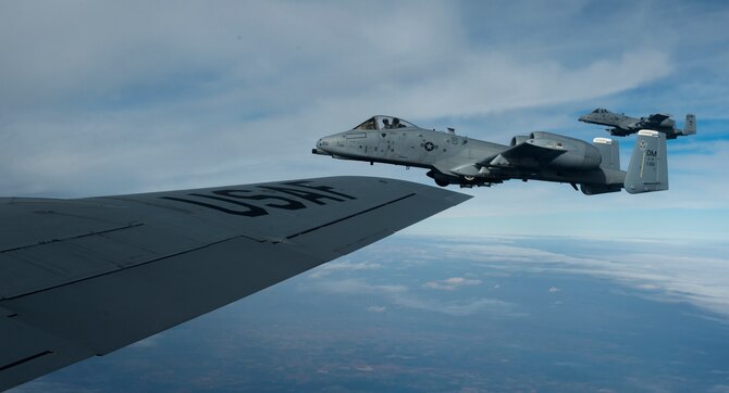 A-10 Thunderbolt IIs from the 354th Expeditionary Fighter Squadron fly next to a KC-135 Stratotanker from the 100th Air Refueling Wing, RAF Mildenhall, England, after performing aerial refueling above Ramstein Air Base, Germany, March 26, 2015. The A-10s deployed as part of a theater security package in support of Operation Atlantic Resolve. These deployments continuously operate on a rotational basis in order to provide the United States European Command commander, and other regional commanders, unique air capabilities necessary to support regional security and participate in distinctive training opportunities with European allies and partners. (U.S. Air Force photo/Senior Airman Damon Kasberg)