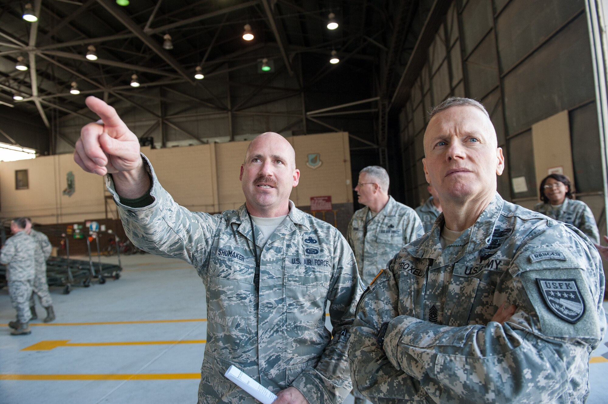 Master Sgt. Brian Shumaker, 8th Maintenance Squadron maintenance flight chief, gives a tour of an F-16 Fighting Falcon to Army Sgt. Maj. John Troxell, U.S. Forces Korea Command Sgt. Maj., during Troxell’s visit to Kunsan Air Base, Republic of Korea, March 23, 2015. During his visit, Troxell saw how the Wolf Pack contributes to deterring aggression on the Korean Peninsula and remains ready to fight tonight. (U.S. Air Force photo by Senior Airman Taylor Curry/Released)