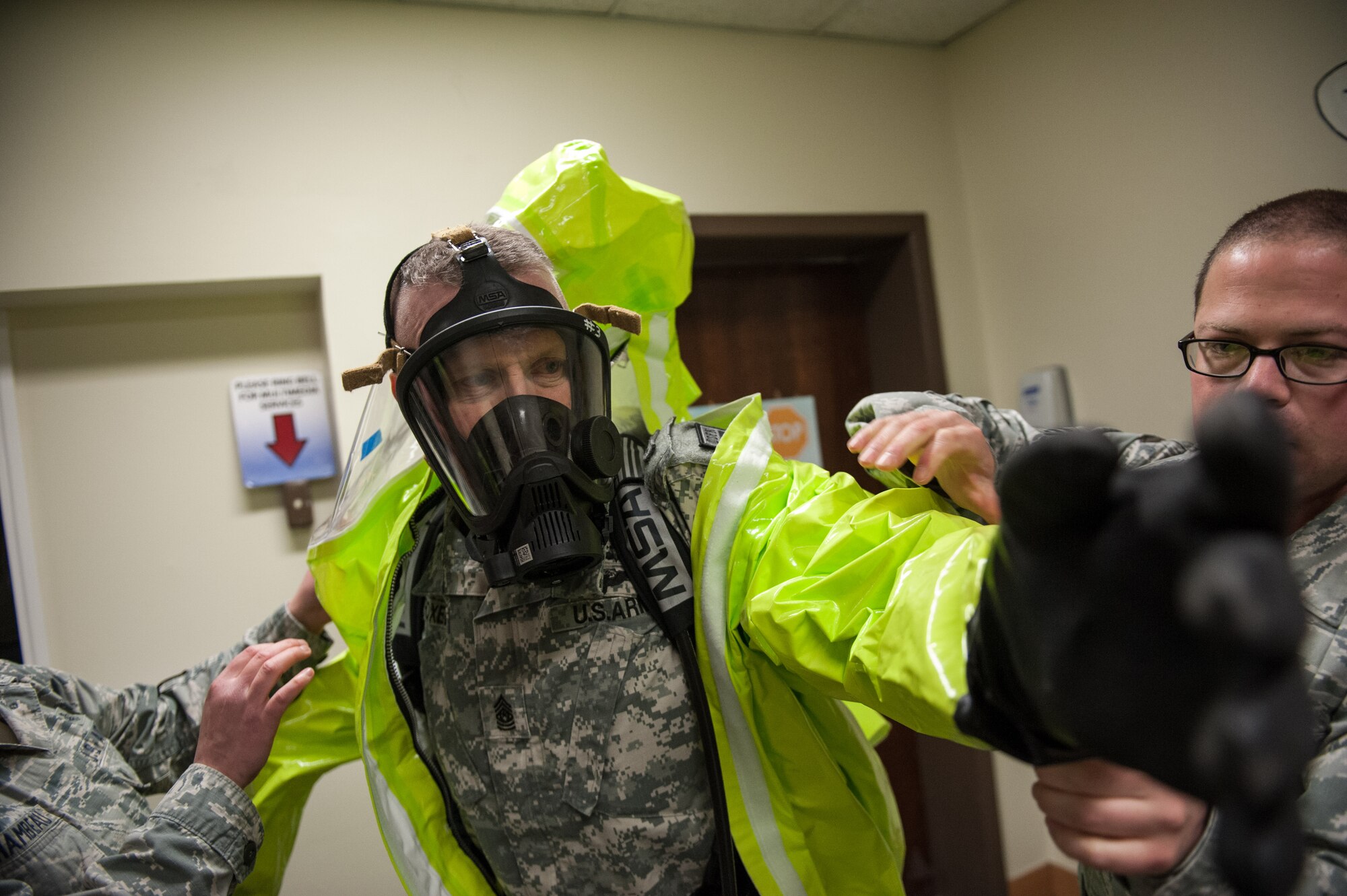 Army Sgt. Maj. John Troxell, U.S. Forces Korea Command Sgt. Maj., puts on a level-A hazardous material protection suit during a tour to the 8th Medical Group’s bioenvironmental section at Kunsan Air Base, Republic of Korea, March 23, 2015. During his visit, Troxell saw how the Wolf Pack contributes to deterring aggression on the Korean Peninsula and remain ready to fight tonight. (U.S. Air Force photo by Senior Airman Taylor Curry/Released)