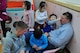 Airmen from the 120th Expeditionary Aircraft Maintenance Unit and 8th Fighter Wing play with children at the Moses Infant Home in Gunsan City, Republic of Korea, March 21, 2015. The Kunsan Chapel provided a special opportunity for the deployed Redeyes to volunteer in Gunsan while deployed to the ROK. (U.S. Air Force photo by Capt. Reba Good/Released)