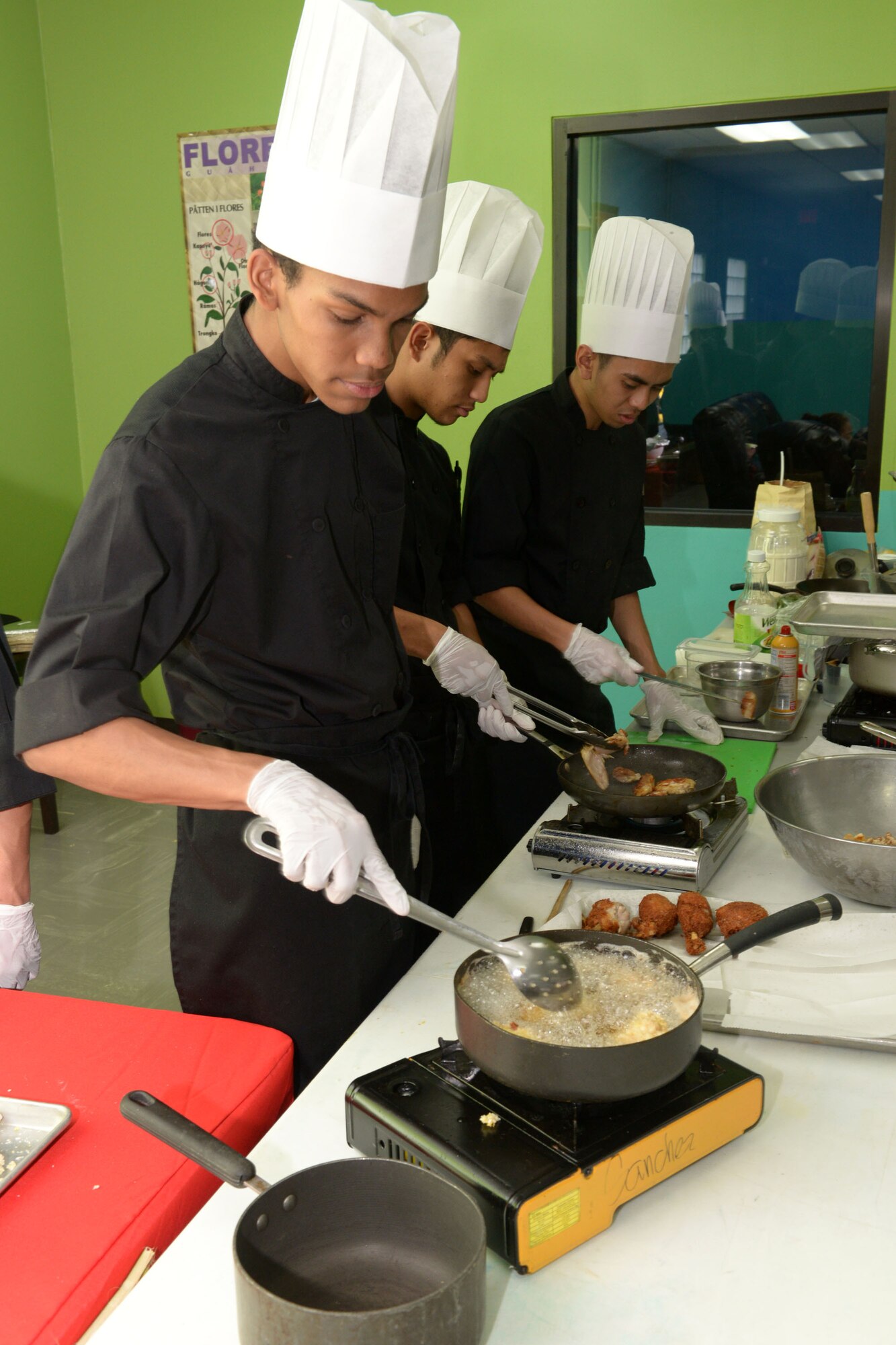 A Simon Sanchez High School student prepares food for the Chamorro Month presentation March 26, 2015, at Andersen Air Force Base, Guam. The 36th FSS hosted activities for Team Andersen children to learn about the Chamorro culture. (U.S. Air Force photo by Airman 1st Class Joshua Smoot/Released)