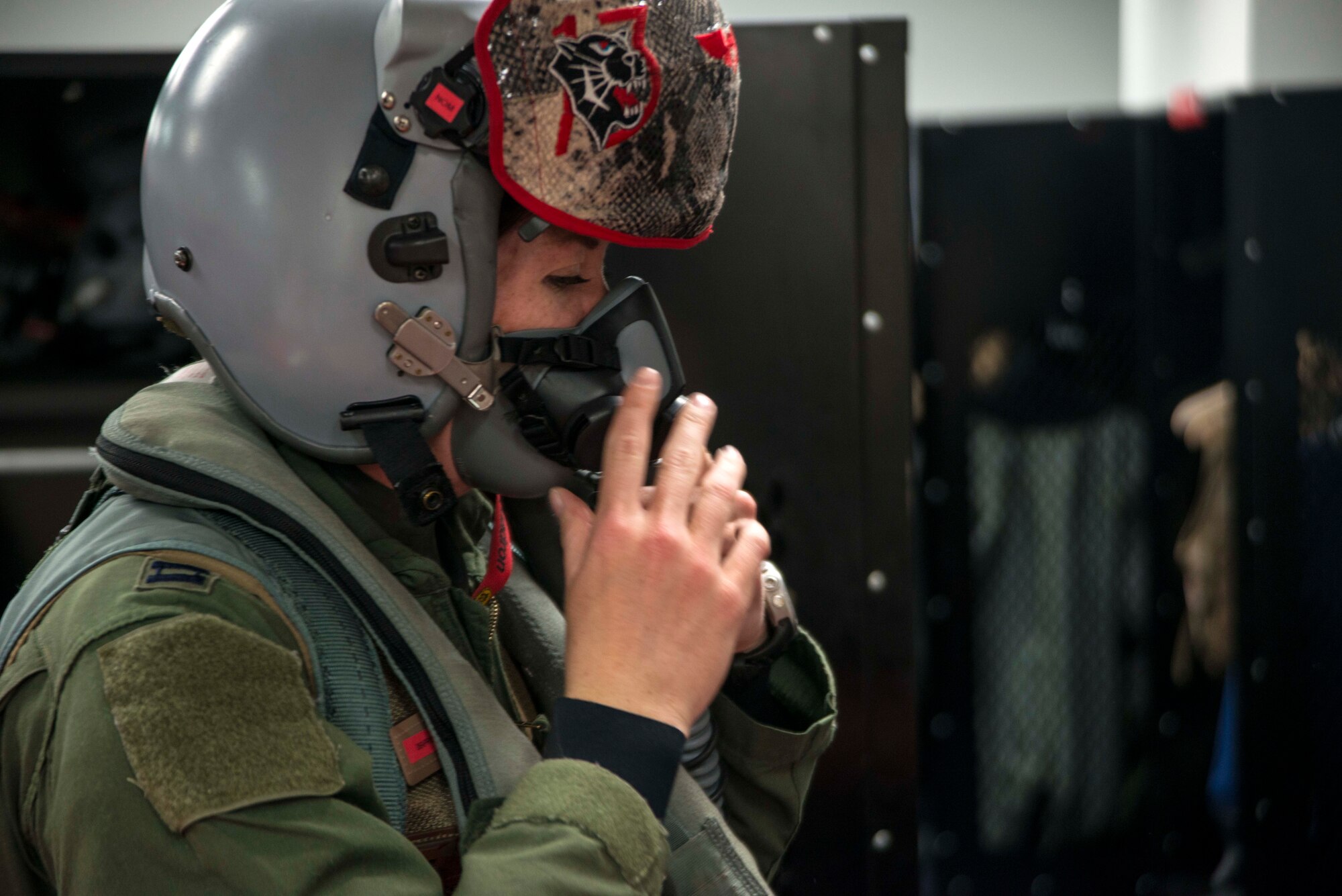 Capt. Michelle Hamland, 13th Fighter Squadron F-16 Fighting Falcon pilot, undergoes a pressure demand leak check on her helmet as she prepares for a Suppression of Enemy Air Defenses training flight March 26, 2015, at Misawa Air Base, Japan. The Aircrew flight equipment flight prepares pilots’ equipment for hundreds of flights each month. (U.S. Air Force photo by Staff Sgt. Derek VanHorn/Released)