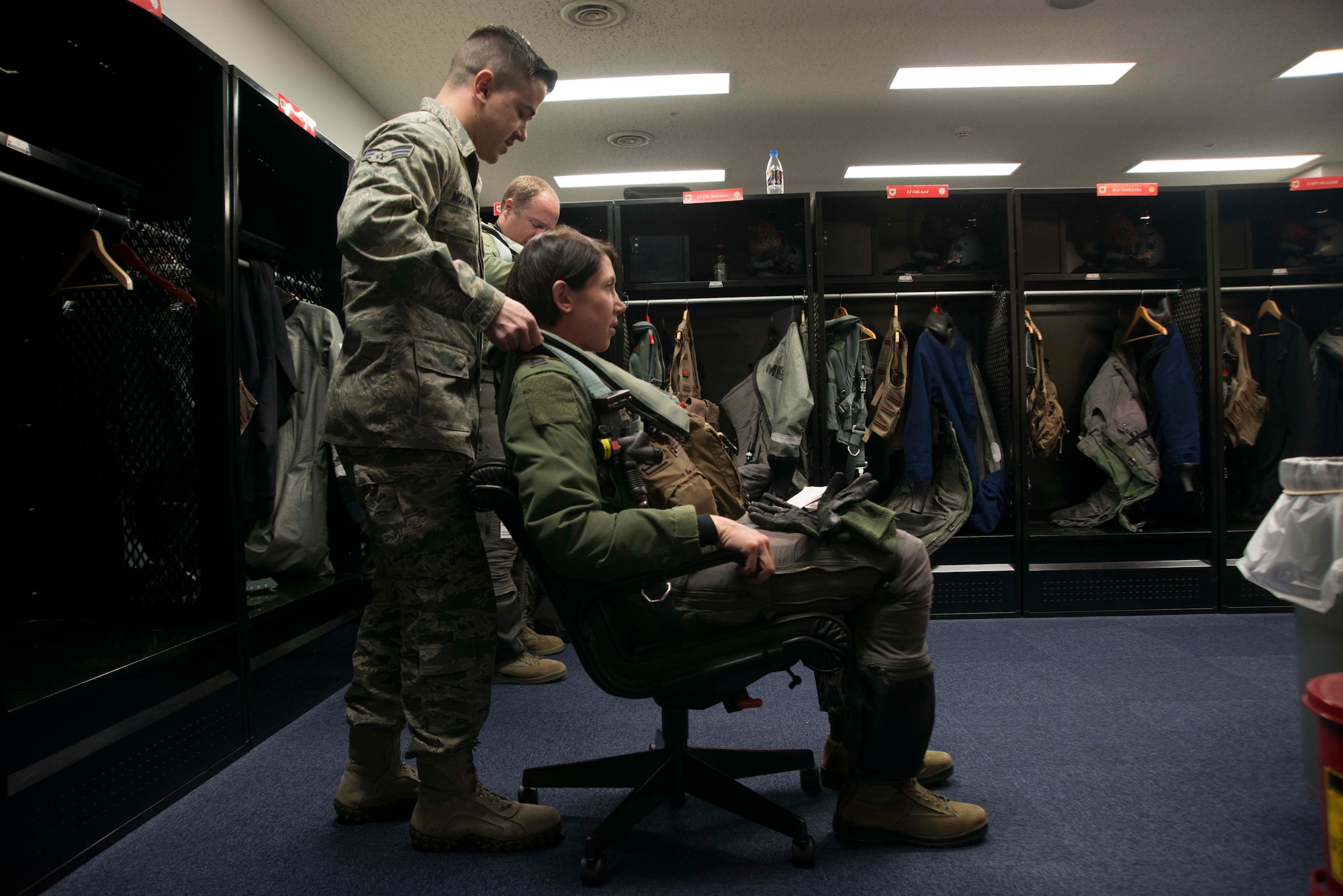 Senior Airman Robert McClung, 13th Fighter Squadron aircrew flight equipment technician, performs a 120-day fit check on Capt. Michelle Hamland’s flight gear March 26, 2015, at Misawa Air Base, Japan. AFE performs scheduled maintenance on all pilot’s gear, including helmet and mask, survival vests, Anti-G suits, anti-exposure suits and harnesses. Hamland is a 13 FS F-16 Fighting Falcon pilot. (U.S. Air Force photo by Staff Sgt. Derek VanHorn/Released)