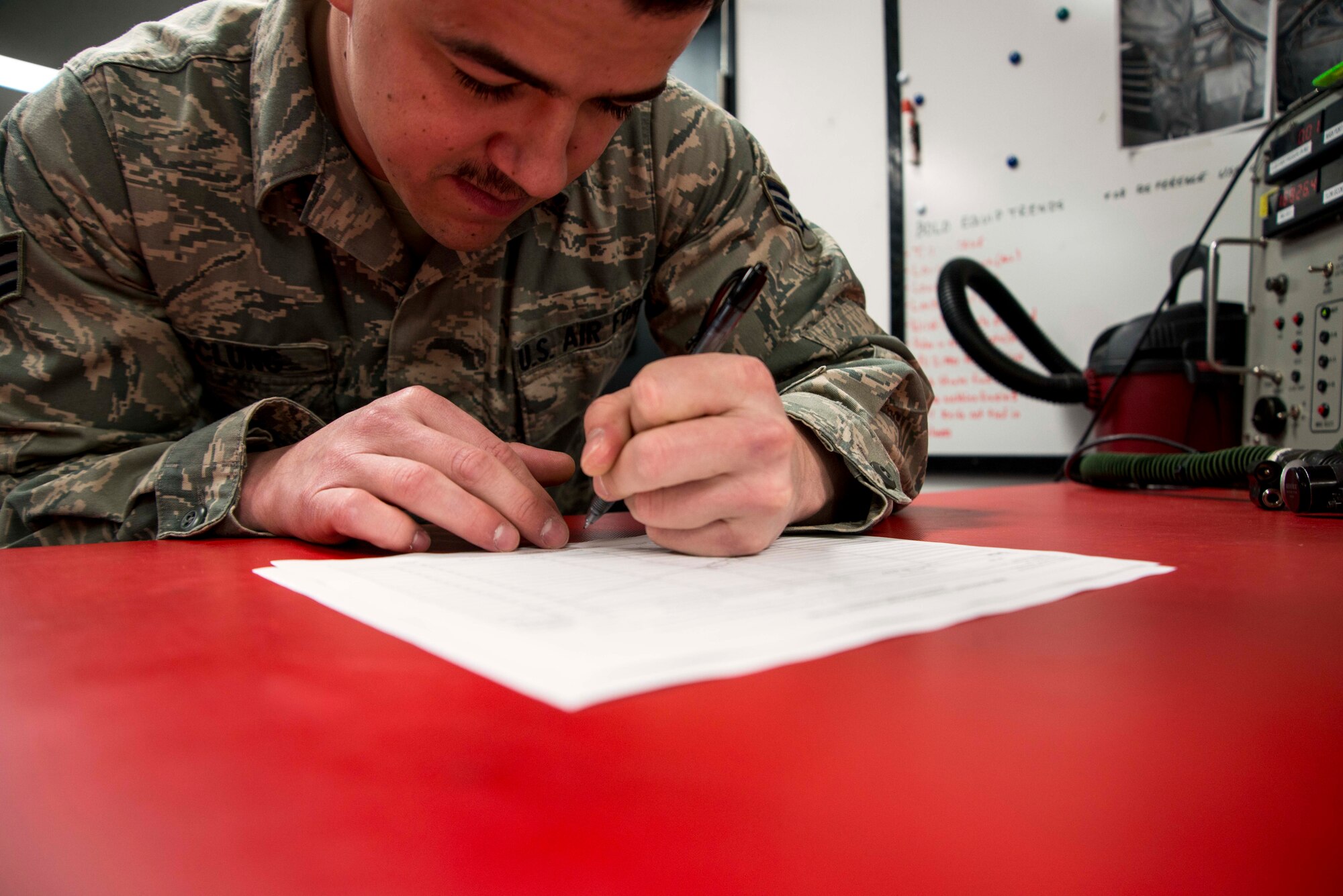 Senior Airman Robert McClung, 13th Fighter Squadron aircrew flight equipment technician, signs off on a 120-day fit check for a pilot’s flying gear March 26, 2015, at Misawa Air Base, Japan. The AFE flight performs scheduled and on-the-go maintenance on flying gear for 35th Fighter Wing F-16 Fighting Falcon pilots. (U.S. Air Force photo by Staff Sgt. Derek VanHorn/Released)