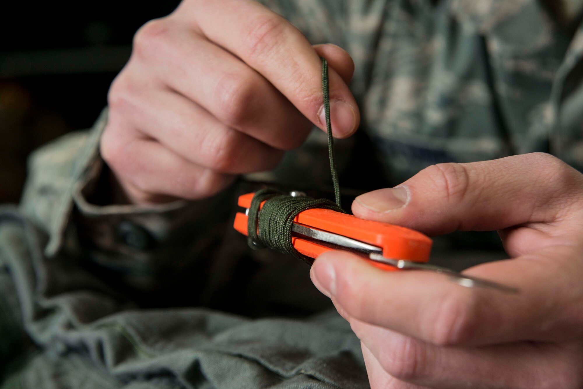 An MC-1 hook blade knife is prepared for installment in a 13th Fighter Squadron pilot’s Anti-G suit before a sortie March 26, 2015, at Misawa Air Base, Japan. The aircrew flight equipment flight prepares the gear all F-16 Fighting Falcon pilots fly with, including items like their helmet and mask, survival vest, anti-exposure suit and harness. (U.S. Air Force photo by Staff Sgt. Derek VanHorn/Released)