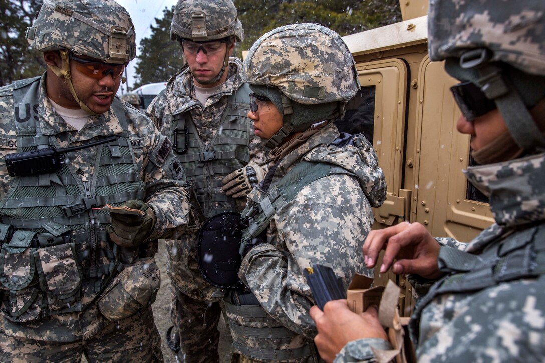 Army Sgt. Dante Gordon, left, gives a safety briefing to Army Spc. Andre Loaiza, Army Pvt. Aspen M. Brown and Army Spc. Keily Y. Caba before participating in battle drills at the training site for military operations in urban terrain on Joint Base McGuire-Dix-Lakehurst, N.J., March 20, 2015. Gordon, Loaiza, Brown and Caba are military police officers assigned to the New Jersey Army National Guard's 328th Military Police Company.
