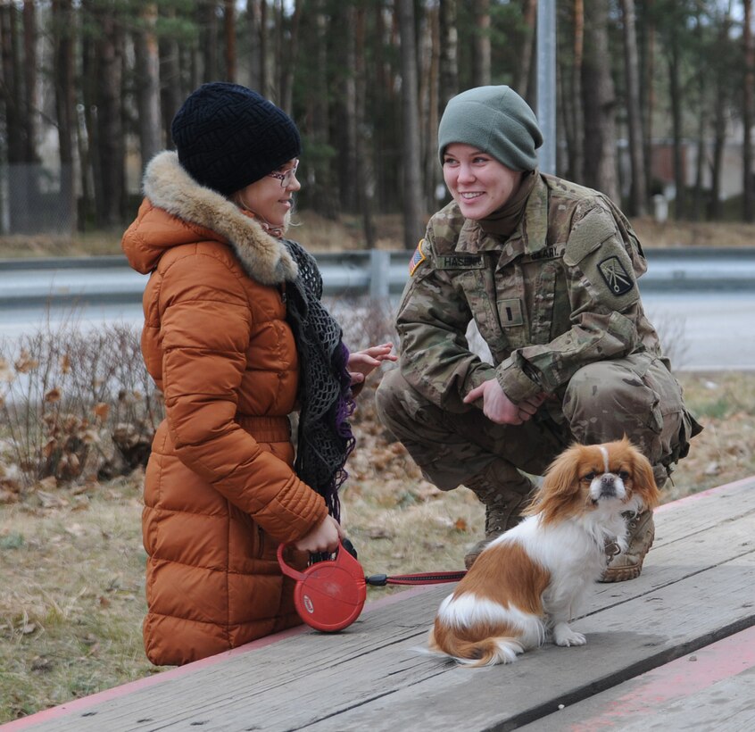 U.S. Army 1st Lt. Stephanie Hasenfus talks to a girl during Operation Dragoon Ride from Tapa, Estonia, to her unit's home base in Vilseck, Germany, March 22, 2015.