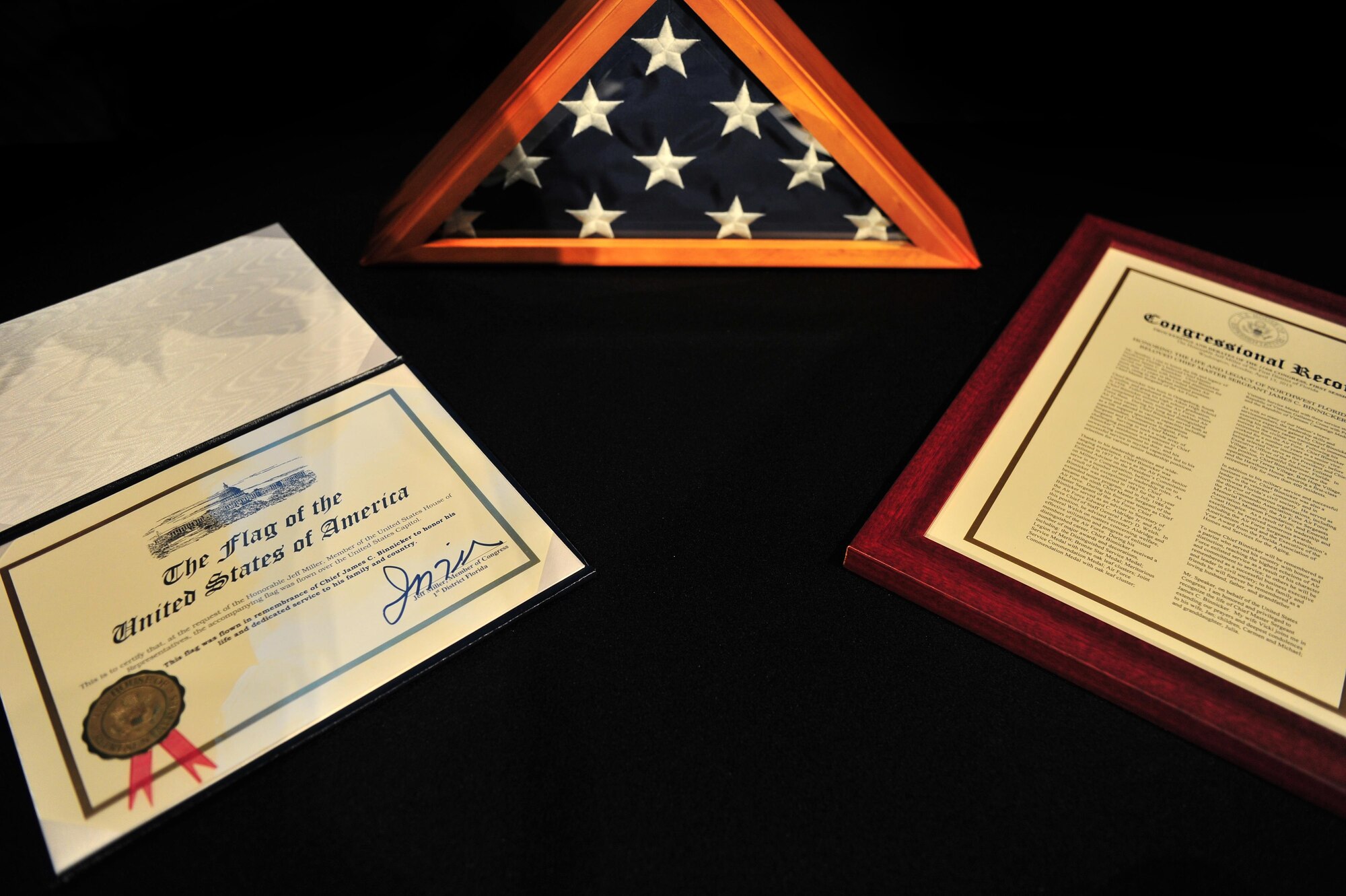 A flag flown over Capitol Hill in honor of Chief Master Sgt. of the Air Force #9 James C. Binnicker’s life is on display during his celebration of life ceremony at the Emerald Coast Convention Center, Fort Walton Beach, Fla., March 28, 2015. During his tenure as the ninth chief master sergeant of the Air Force, Binnicker led the transformation from the Airman Performance Report to the Enlisted Performance Report, and developed the performance feedback system. He also worked to have master sergeants admitted to the Air Force Senior NCO Academy, and to increase the opportunities for minorities and women throughout the Air Force.  (U.S. Air Force photo by Airman 1st Class Ryan Conroy/Released)