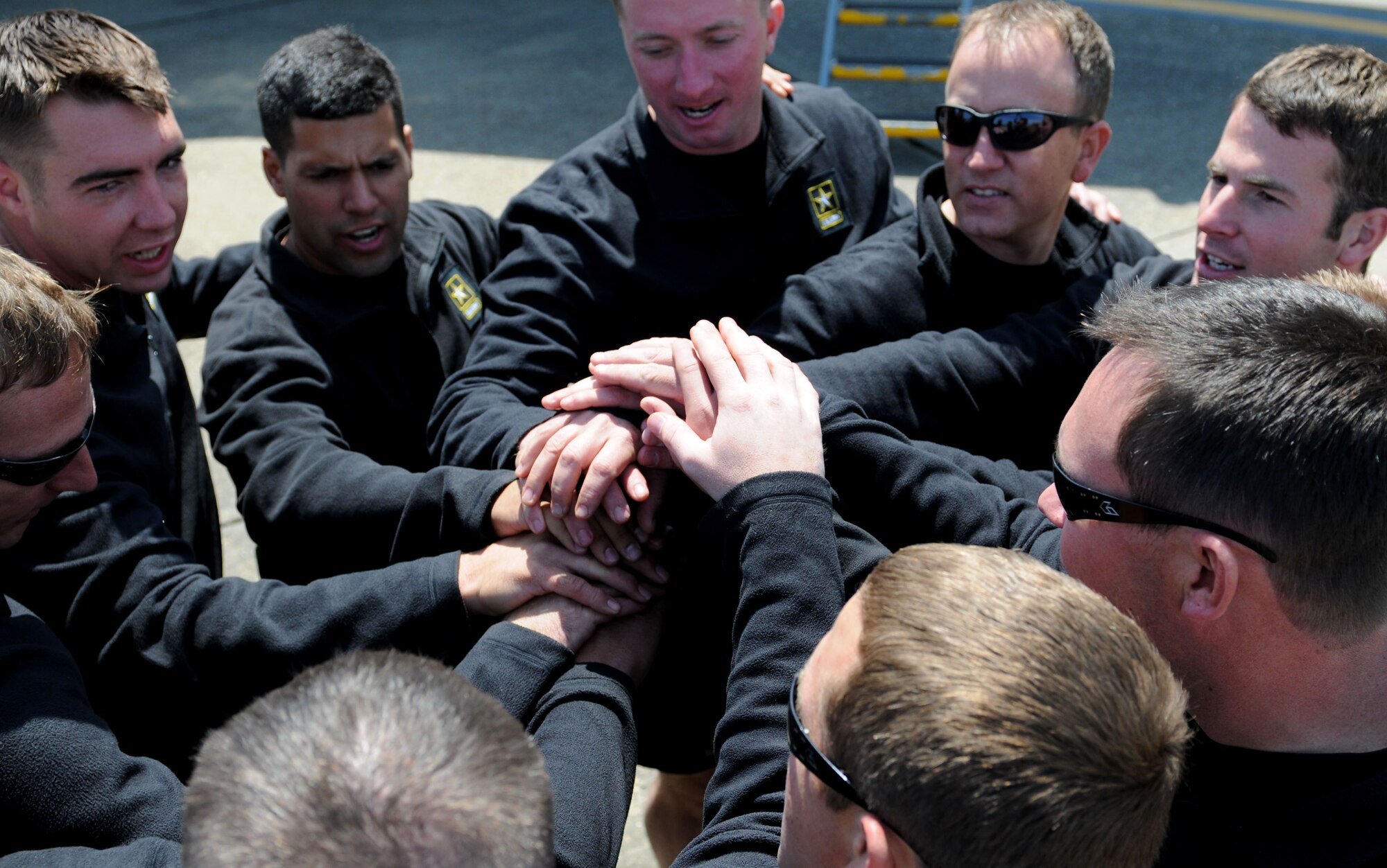 Members of the U.S. Army Parachute Team “Golden Knights” Team Black form a huddle before boarding their C-31A for their afternoon performance at the 2015 Keesler Air Show/Open House, March 28, 2015, Keesler Air Force Base, Miss. This was Keesler’s first air show since 2011, and featured 17 aerial acts, 27 static displays and was headlined by the U.S. Air Force Thunderbirds Aerial Demonstration Team. (U.S. Air Force photo by Airman 1st Class Duncan McElroy)