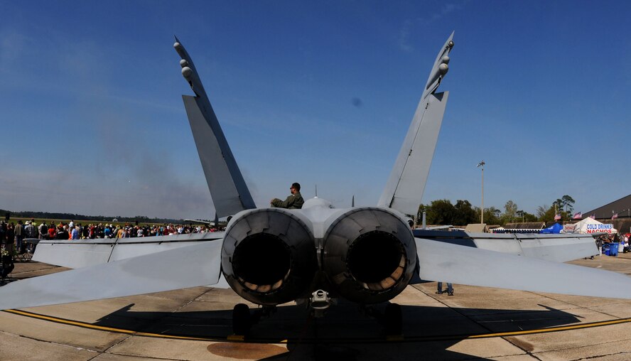 An F/A-18 Hornet pilot sits on his aircraft and watches the U.S. Air Force Thunderbirds Aerial Demonstration Team perform at the 2015 Keesler Air Show/Open House, March 28, 2015, Keesler Air Force Base, Mississippi. The F/A-18 was one of 27 static displays at the air show. (U.S. Air Force photo by Airman 1st Class Duncan McElroy)