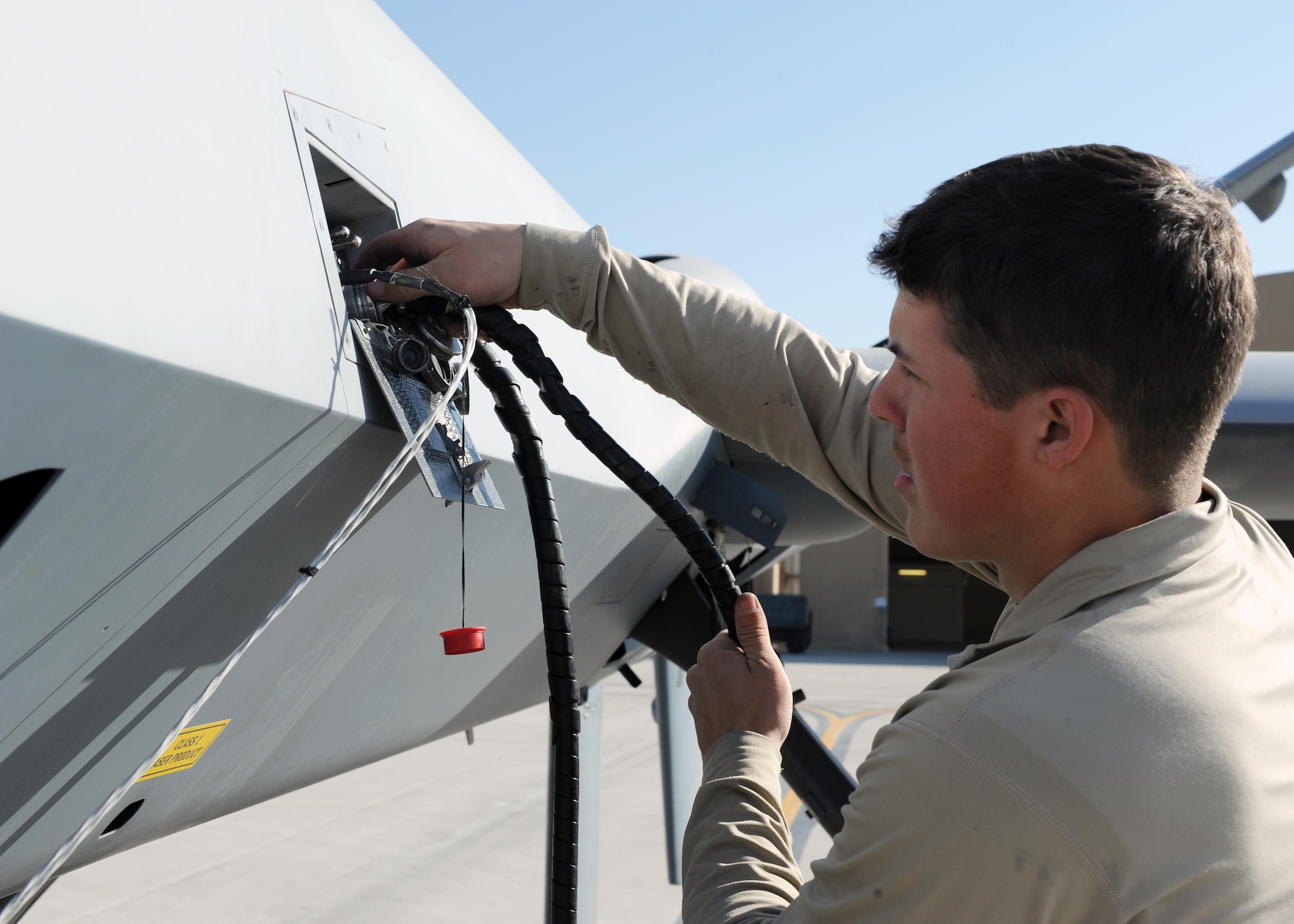 U.S. Air Force Airman Alex, 451st Expeditionary Aircraft Maintenance Squadron crew chief, performs preflight checks prior to launching an MQ-9 Reaper March 20, 2015 at Kandahar Airfield, Afghanistan. Airmen assigned to the 451 EAMXS provide 24/7 maintenance support to the Air Force’s largest Reaper unit, ensuring ground troops are supported around the clock. (U.S. Air Force photo by Staff Sgt. Whitney Amstutz/released)