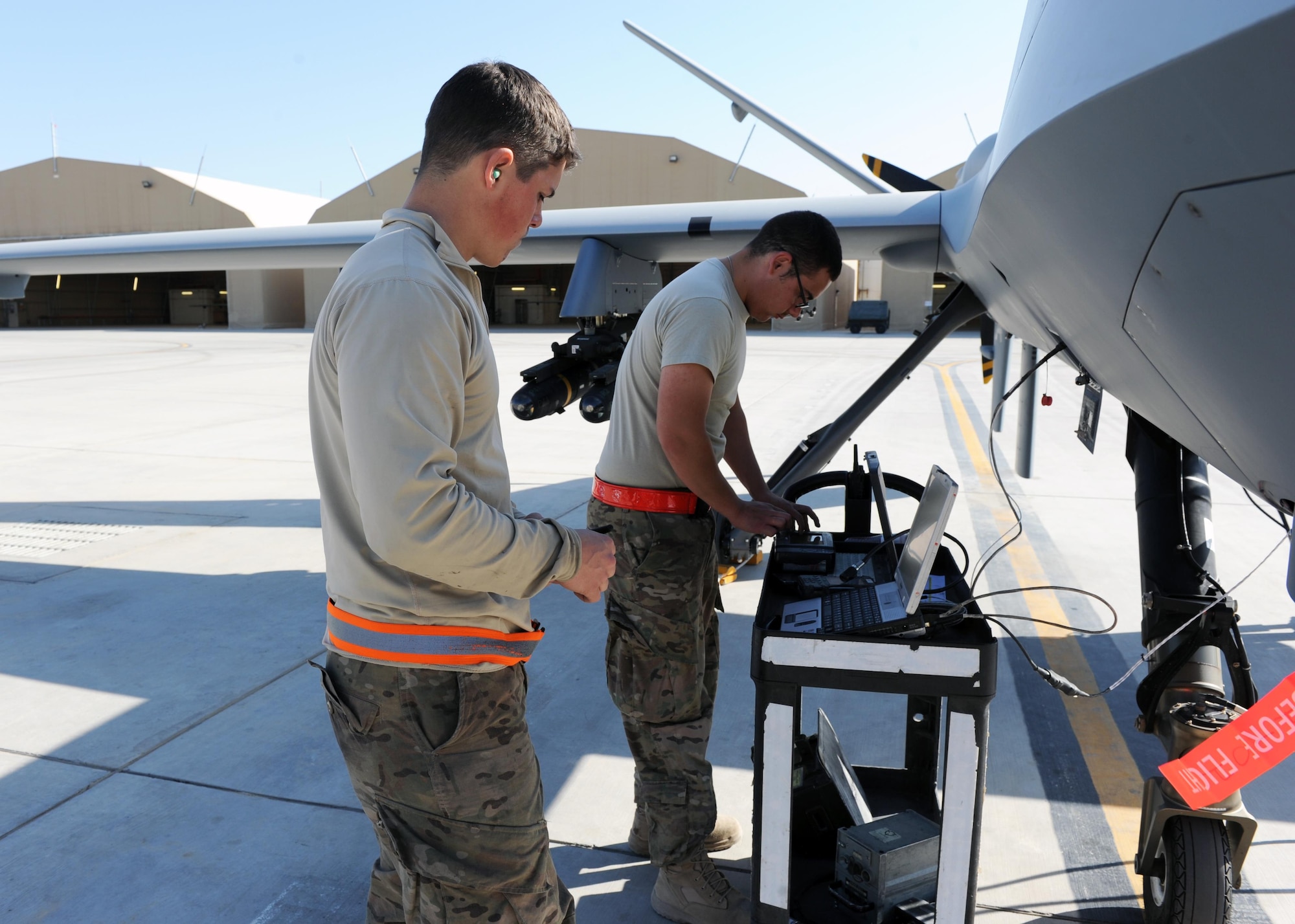 U.S. Air Force Airmen assigned to the 451st Expeditionary Aircraft Maintenance Squadron perform preflight checks prior to launching an MQ-9 Reaper March 20, 2015 at Kandahar Airfield, Afghanistan. Airmen assigned to the 451 EAMXS provide 24/7 maintenance support to the Air Force’s largest Reaper unit, ensuring ground troops are supported around the clock. (U.S. Air Force photo by Staff Sgt. Whitney Amstutz/released)