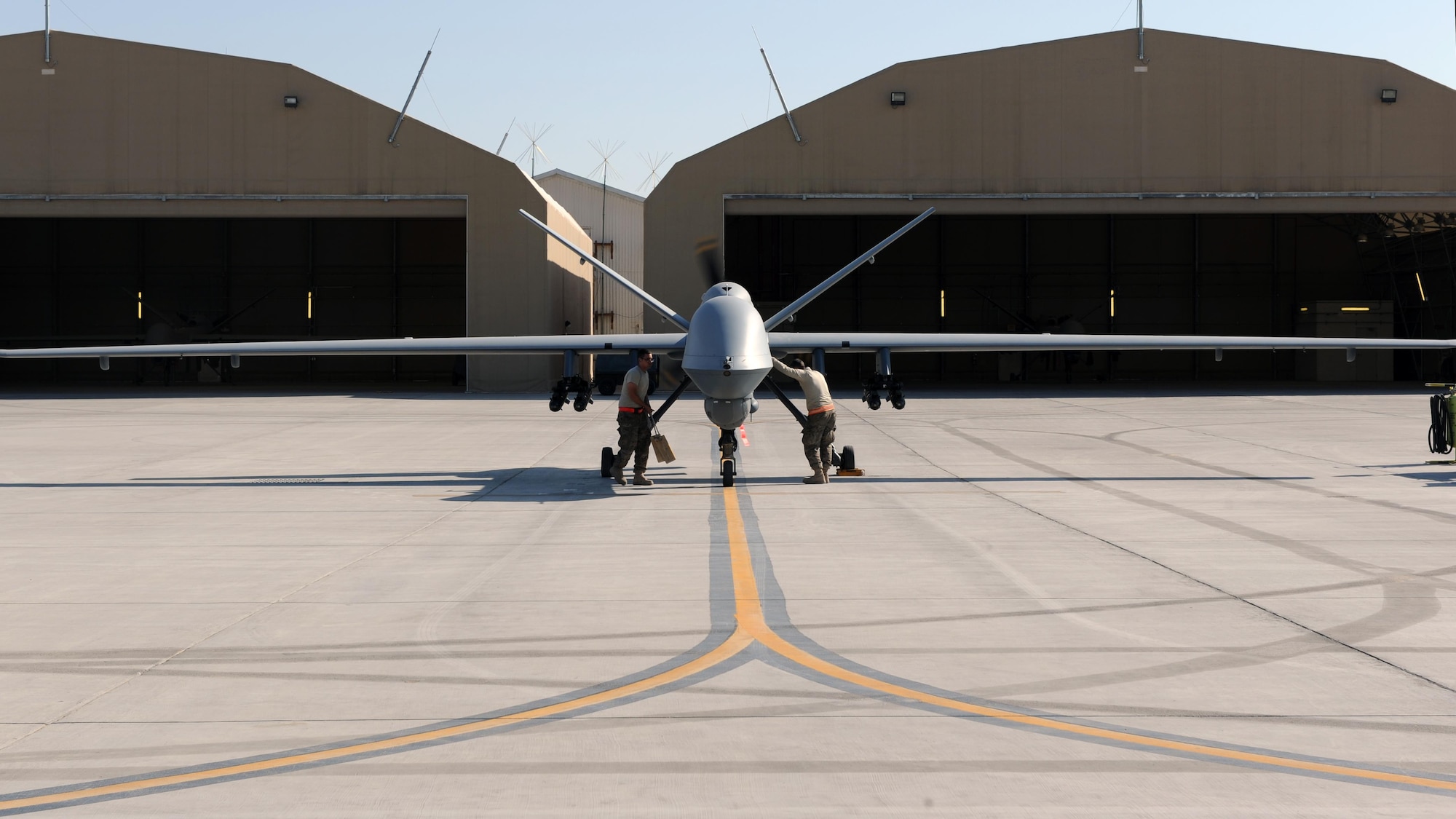 U.S. Air Force Airmen assigned to the 451st Expeditionary Aircraft Maintenance Squadron perform preflight checks prior to launching an MQ-9 Reaper March 20, 2015 at Kandahar Airfield, Afghanistan. Airmen assigned to the 451 EAMXS provide 24/7 maintenance support to the Air Force’s largest Reaper unit, ensuring ground troops are supported around the clock. (U.S. Air Force photo by Staff Sgt. Whitney Amstutz/released)