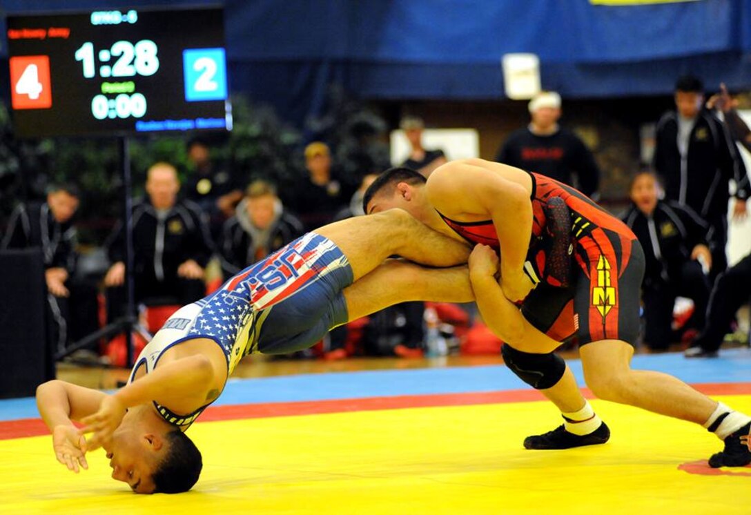Sgt. Max Nowry of the U.S. Army World Class Athlete Program gets a leg lace on Lance Cpl. Rueben Navejas of Marine Corps Base Camp Lejeune, North Carolina, en route to a 9-2 victory in the 57-kilogram freestyle division of the 2015 Armed Forces Wresting Championships to help All-Army to a 22-14 victory over All-Marine Corps on Saturday at the Morale, Welfare and Recreation Special Events Center on Fort Carson, Colorado. U.S. Army photo by Tim Hipps, IMCOM Public Affairs