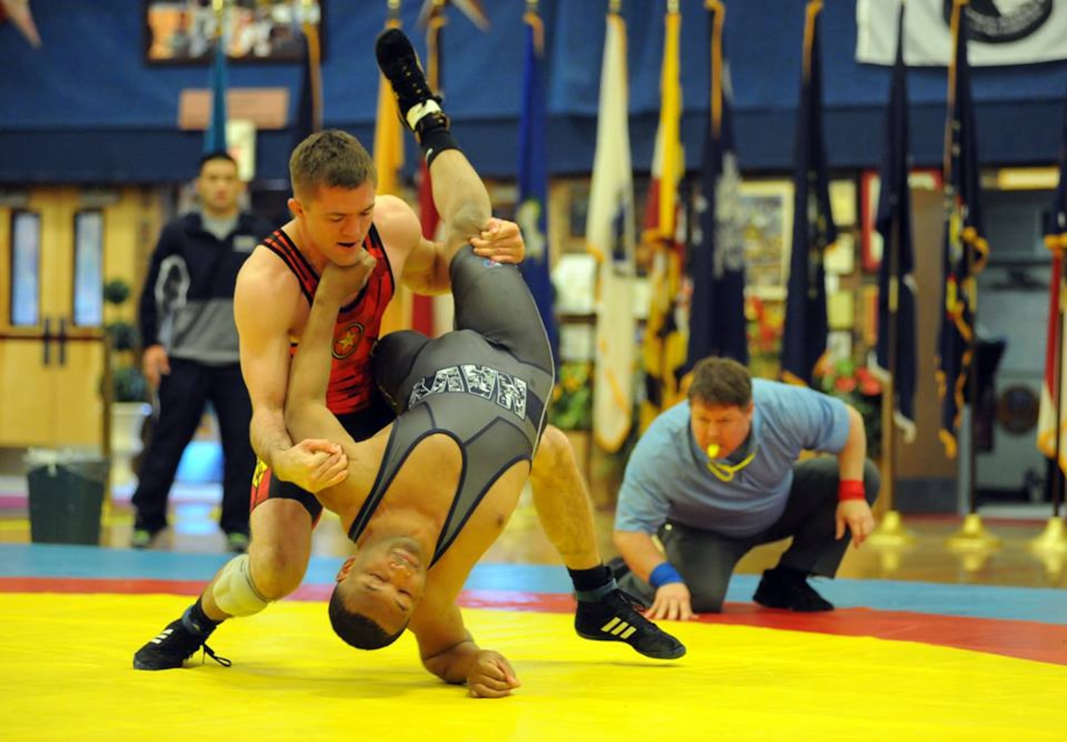 Sgt. Moza Fay (left) of the U.S. Army World Class Athlete Program pins Petty Officer 3 Ronald Latimer of the USS America at San Diego, California, in 24 seconds to help All-Army to a 35-4 victory over All-Navy in the opening freestyle session of the 2015 Armed Forces Wrestling Championships on Saturday at the Morale, Welfare and Recreation Special Events Center on Fort Carson, Colorado. U.S. Army photo by Tim Hipps, IMCOM Public Affairs