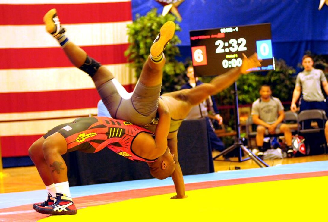 Sgt. Caylor Williams of the U.S. Army World Class Athlete Program throws PO2 Antonio Harris of the Naval Mobile Construction Battalion at Dover, Delaware, during Army's 29-4 victory over Navy in the opening session of the 2015 Armed Forces Wrestling Championships on Friday at the Army Morale, Welfare and Recreation Special Events Center on Fort Carson, Colorado. U.S. Army photo by Tim Hipps, IMCOM Public Affairs