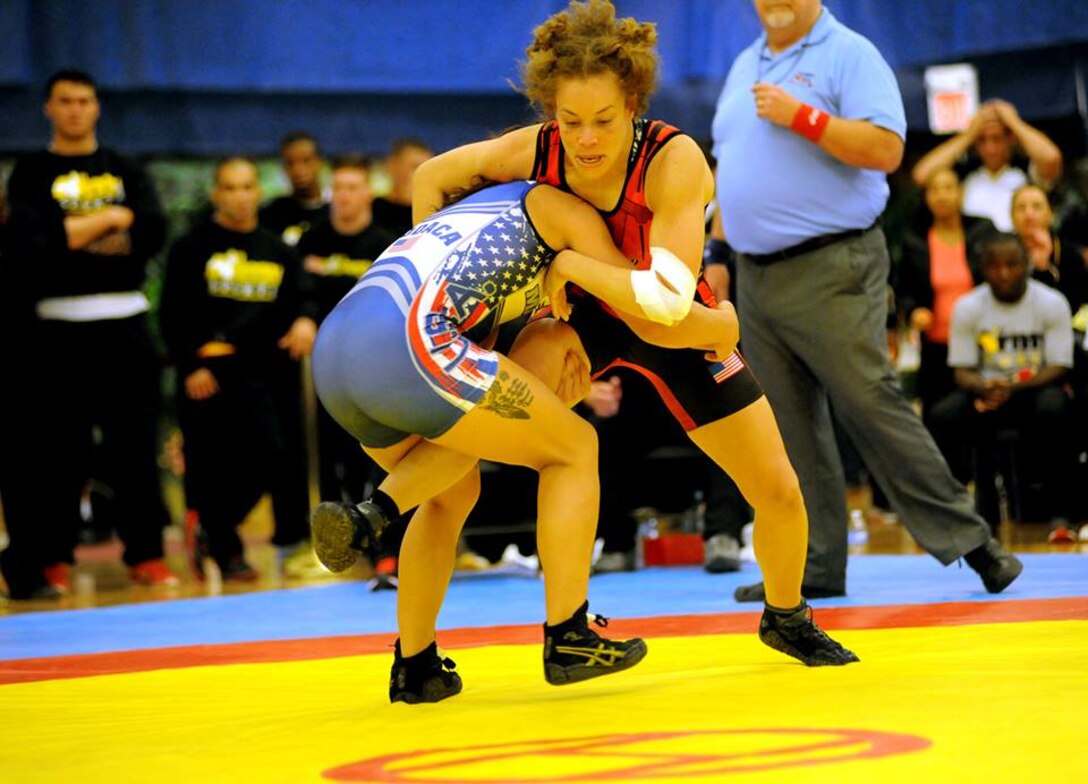 All-Army wrestler Capt. Leigh Provisor (top in red) of Fort Carson, Colorado, eventually pins All-Marine Corps Cpl. Melissa Apodaca of Marine Corps Base Camp Lejeune, North Carolina, in the inaugural women's match in the Armed Forces Wrestling Championships on Saturday at the Morale, Welfare and Recreation Special Events Center on Fort Carson. U.S. Army photo by Tim Hipps, IMCOM Public Affairs