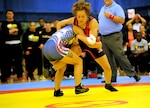 All-Army wrestler Capt. Leigh Provisor (top in red) of Fort Carson, Colorado, eventually pins All-Marine Corps Cpl. Melissa Apodaca of Marine Corps Base Camp Lejeune, North Carolina, in the inaugural women's match in the Armed Forces Wrestling Championships on Saturday at the Morale, Welfare and Recreation Special Events Center on Fort Carson. U.S. Army photo by Tim Hipps, IMCOM Public Affairs