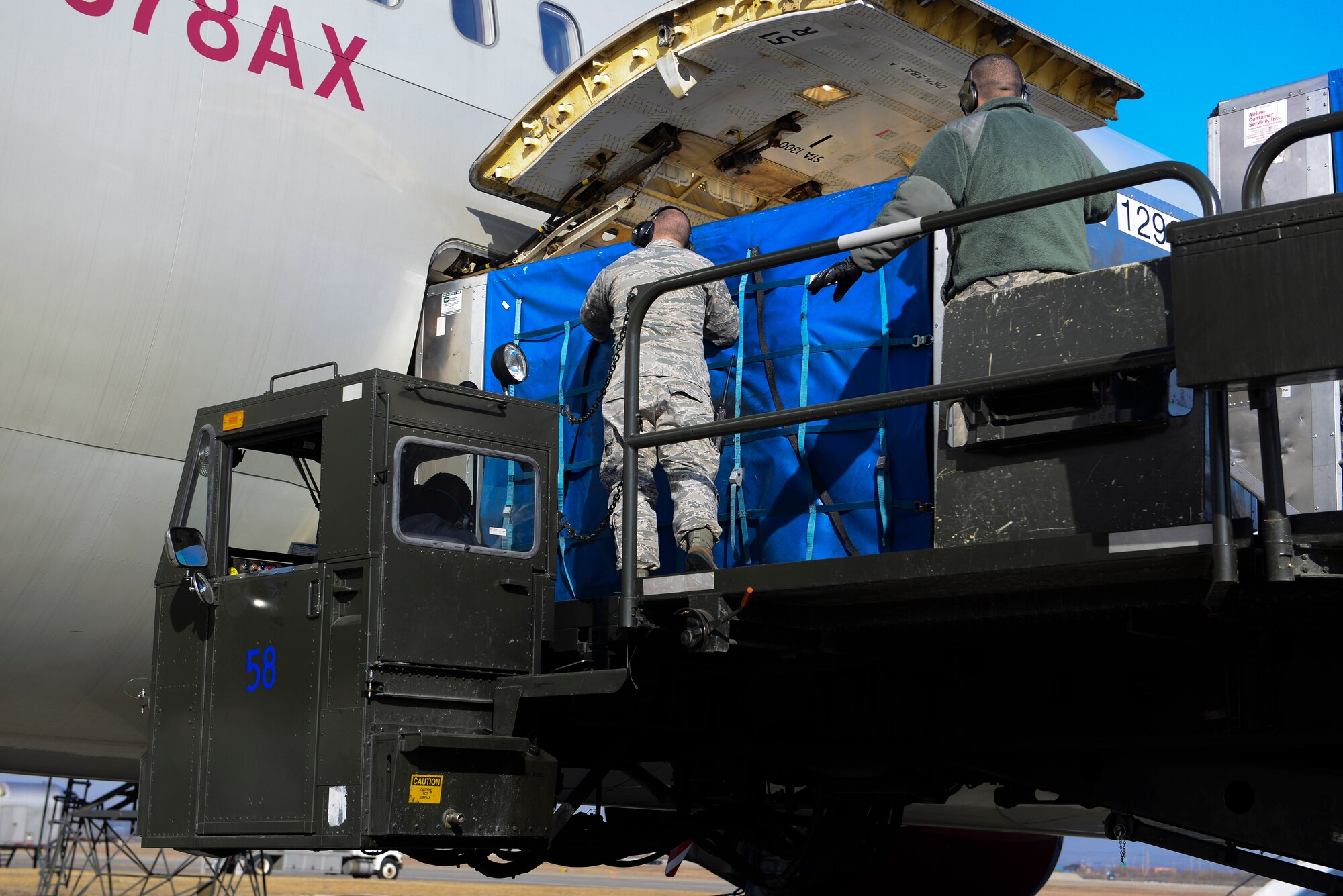 Airmen from the 731st Air Mobility Squadron load a baggage bin into an aircraft March 12, 2015 at Osan Air Base, Republic of Korea. Baggage download and upload times have decreased since the implementation of the new process. (U.S. Air Force photo by Senior Airman David Owsianka)