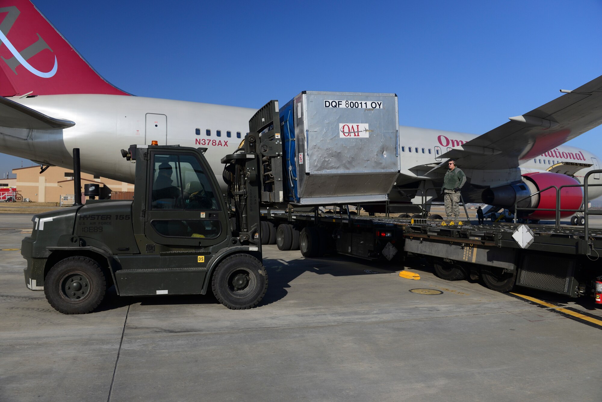Members from the 731st Air Mobility Squadron prepare to a load baggage bin into an aircraft March 12, 2015, at Osan Air Base, Republic of Korea. The new process enables the squadron to become more efficient while utilizing their manpower, which might have been required at the aircraft, to perform another mission. (U.S. Air Force photo by Senior Airman David Owsianka)