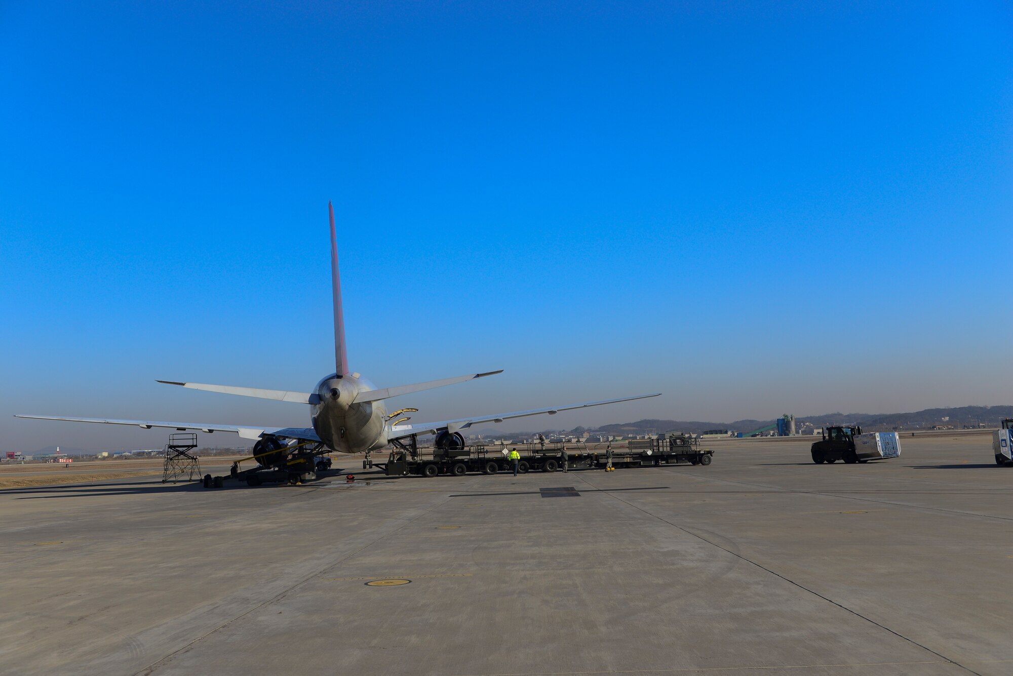 Members from the 731st Air Mobility Squadron prepare to load baggage bins into an aircraft March 12, 2015, at Osan Air Base, Republic of Korea. The new process has decreased personnel needed to operate from seven to five and a reduction in operating time down by 43 minutes. (U.S. Air Force photo by Senior Airman David Owsianka)