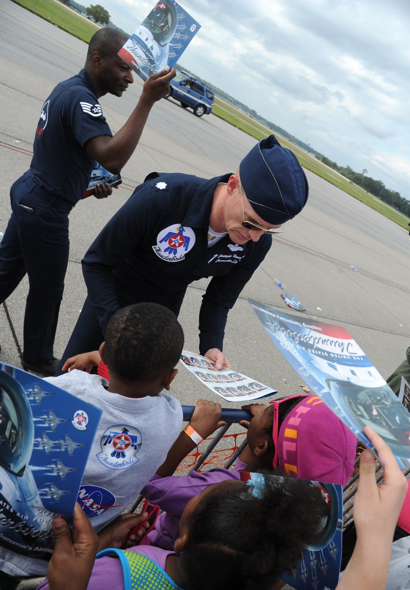 Lt. Col. Christopher Hammond, U.S. Air Force Thunderbird #1, autographs Thunderbirds programs during Keesler’s 2015 Air Show/Open House March 29, 2015, at Keesler Air Force Base, Miss. The Thunderbirds headlined the two-day event held March 28-29.  Approximately 155,000 people were in attendance for the two-day show. (U.S. Air Force photo by Kemberly Groue)