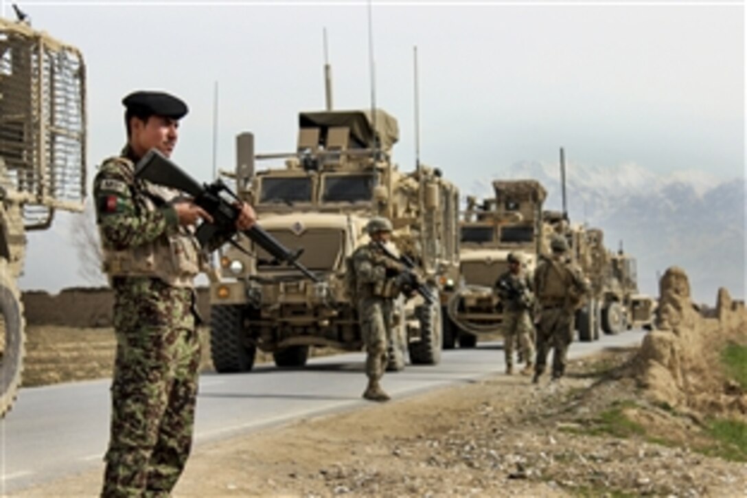 U.S. Marines and U.S., Afghan and Georgian soldiers prepare to patrol outside of the Qaleh Musa Pain village in Helmand province, Afghanistan, March 12, 2015. The U.S. troops are assigned to U.S. Forces Afghanistan, Task Force Solid.
