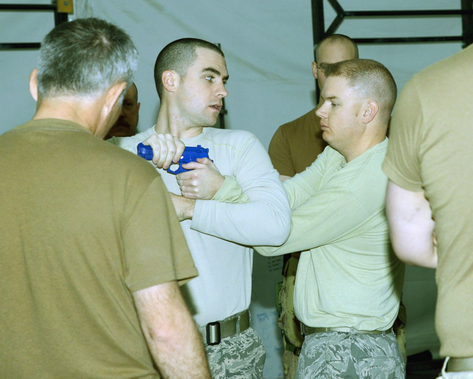 Staff Sgt. Christopher Crean (left) and Tech. Sgt. Taylor Rogal, 386th Expeditionary Security Forces Squadron Check Six, demonstrate combatives Feb. 22, 2015. The Check Six team taught the 10-hour class to 17 Canadian Armed Forces members. (U.S. Air Force photo by Tech. Sgt. Jared Marquis/released)