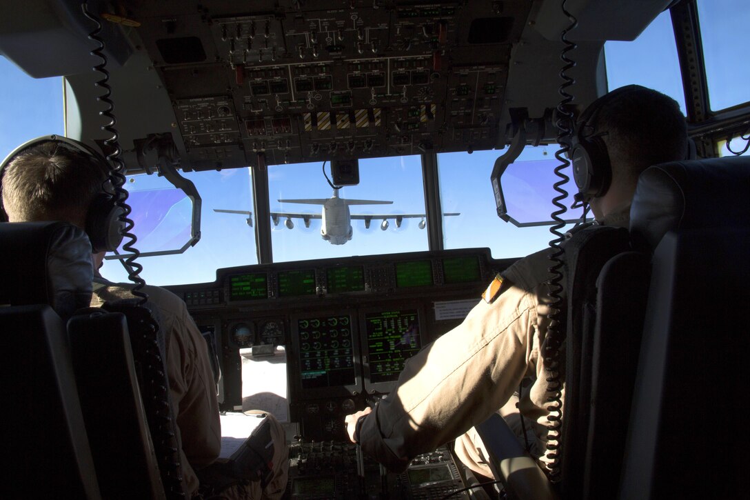 U.S. Marine Captains Sean Elliott (left) and Orlando Samudio (right), KC-130J pilots with Special-Purpose Marine Air-Ground Task Force Crisis Response-Africa, conduct a formation flight near Moròn Air Base, Spain, March 25, 2015. The Hercules, primarily utilized to transport assets or refuel other aircraft, is one of two platforms included in the aviation combat element of the SPMAGTF. (U.S. Marine Corps photograph by 1st Lt. Danielle Dixon/Released)