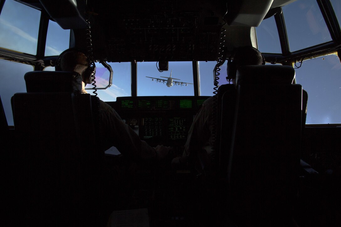 U.S. Marine Captains Sean Elliott (left) and Orlando Samudio (right), KC-130J pilots with Special-Purpose Marine Air-Ground Task Force Crisis Response-Africa, conduct a formation flight near Moròn Air Base, Spain, March 25, 2015. The Hercules, primarily utilized to transport assets or refuel other aircraft, is one of two platforms included in the aviation combat element of the SPMAGTF. (U.S. Marine Corps photograph by 1st Lt. Danielle Dixon/Released)