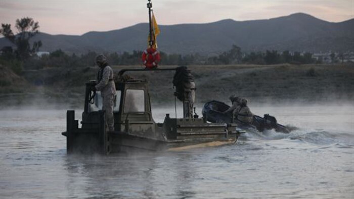 Marines from Bridge Company, 7th Engineer Support Battalion, 1st Marine Logistics Group, conduct a bridge exercise at Lake Elsinore, California, March 24, 2015. Marines built an improved ribbon bridge and a medium girder bridge. This event marks the first time a continuous span bridge from shore to shore has been built since 2002.