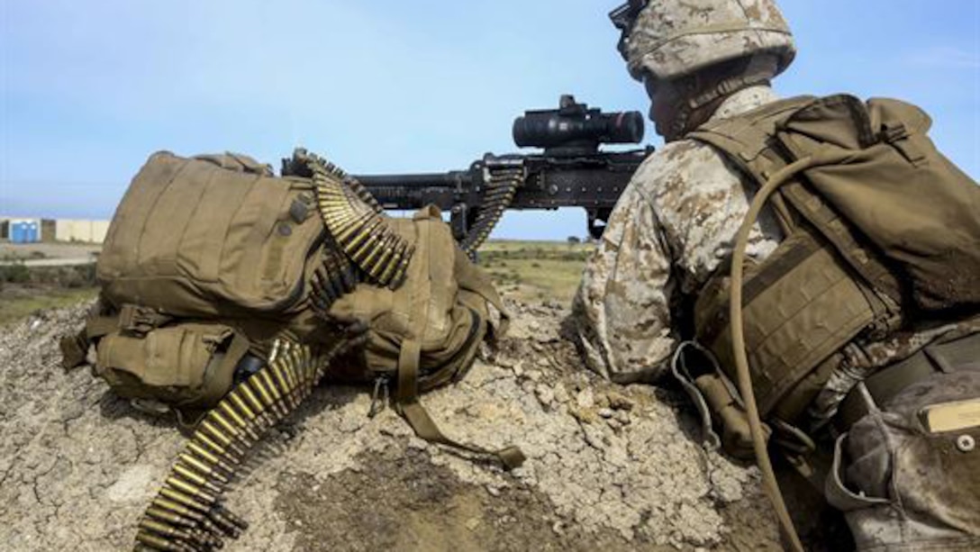 A U.S. Marine with Lima Company, Battalion Landing Team 3rd Battalion, 1st Marine Regiment, 15th Marine Expeditionary Unit, watches over the objective during an airfield seizure mission as part of Composite Training Unit Exercise on San Clemente Island, California., March 22, 2015. These Marines inserted onto the island to execute a raid and practice their urban combat skills.