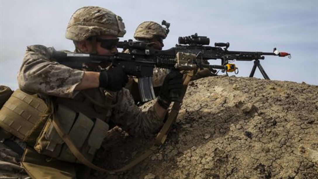 U.S. Marines with Lima Company, Battalion Landing Team 3rd Battalion, 1st Marine Regiment, 15th Marine Expeditionary Unit, provide over-watch on their objective during an airfield seizure mission as part of Composite Training Unit Exercise on San Clemente Island, California, March 22, 2015. These Marines inserted onto the island from the USS Essex (LHD 2) to execute a raid and practice their urban combat skills.
