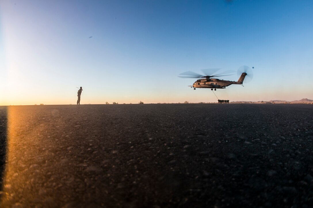 U.S. Marines attending the infantry officers course conduct fast rope training in preparation for Talon Reach during Weapons and Tactics Instructor Course (WTI 2-15) at Auxiliary Airfield 2 near Yuma, AZ., March 26, 2015. WTI is a seven-week event hosted by Marine Aviation Weapons and Tactics Squadron One (MAWTS-1) cadre. MAWTS-1 provides standardized tactical training and certification of unit instructor qualifications to support Marine aviation Training and Readiness and assists in developing and employing aviation weapons and tactics. (U.S. Marine Corps photo by Lance Cpl. Jodson B. Graves 2d MAW Combat Camera/Released)