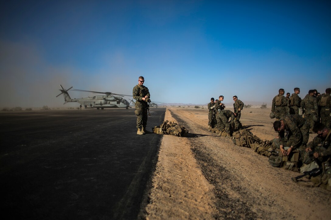 U.S. Marines attending the infantry officers course prepare to conduct fast rope training in preparation for Talon Reach during Weapons and Tactics Instructor Course (WTI 2-15) at Auxiliary Airfield 2 near Yuma, AZ., March 26, 2015. WTI is a seven-week event hosted by Marine Aviation Weapons and Tactics Squadron One (MAWTS-1) cadre. MAWTS-1 provides standardized tactical training and certification of unit instructor qualifications to support Marine aviation Training and Readiness and assists in developing and employing aviation weapons and tactics. (U.S. Marine Corps photo by Lance Cpl. Jodson B. Graves 2d MAW Combat Camera/Released)