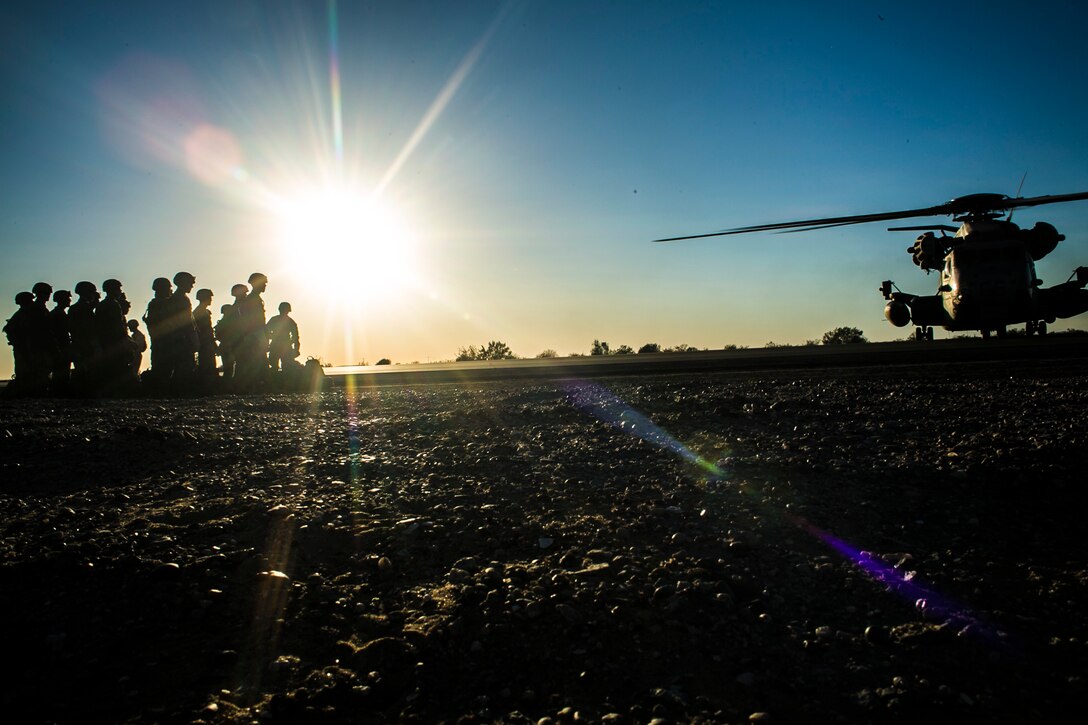 U.S. Marines attending the infantry officers course prepare to conduct fast rope training in preparation for Talon Reach during Weapons and Tactics Instructor Course (WTI 2-15) at Auxiliary Airfield 2 near Yuma, AZ., March 26, 2015. WTI is a seven-week event hosted by Marine Aviation Weapons and Tactics Squadron One (MAWTS-1) cadre. MAWTS-1 provides standardized tactical training and certification of unit instructor qualifications to support Marine aviation Training and Readiness and assists in developing and employing aviation weapons and tactics. (U.S. Marine Corps photo by Lance Cpl. Jodson B. Graves 2d MAW Combat Camera/Released)