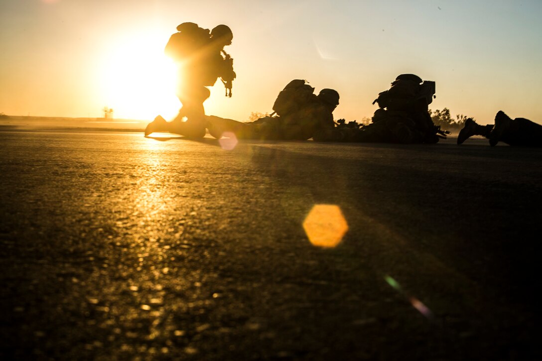 U.S. Marines attending the infantry officers course establish a perimeter during fast rope training in preparation for Talon Reach during Weapons and Tactics Instructor Course (WTI 2-15) at Auxiliary Airfield 2 near Yuma, AZ., March 26, 2015. WTI is a seven-week event hosted by Marine Aviation Weapons and Tactics Squadron One (MAWTS-1) cadre. MAWTS-1 provides standardized tactical training and certification of unit instructor qualifications to support Marine aviation Training and Readiness and assists in developing and employing aviation weapons and tactics. (U.S. Marine Corps photo by Lance Cpl. Jodson B. Graves 2d MAW Combat Camera/Released)