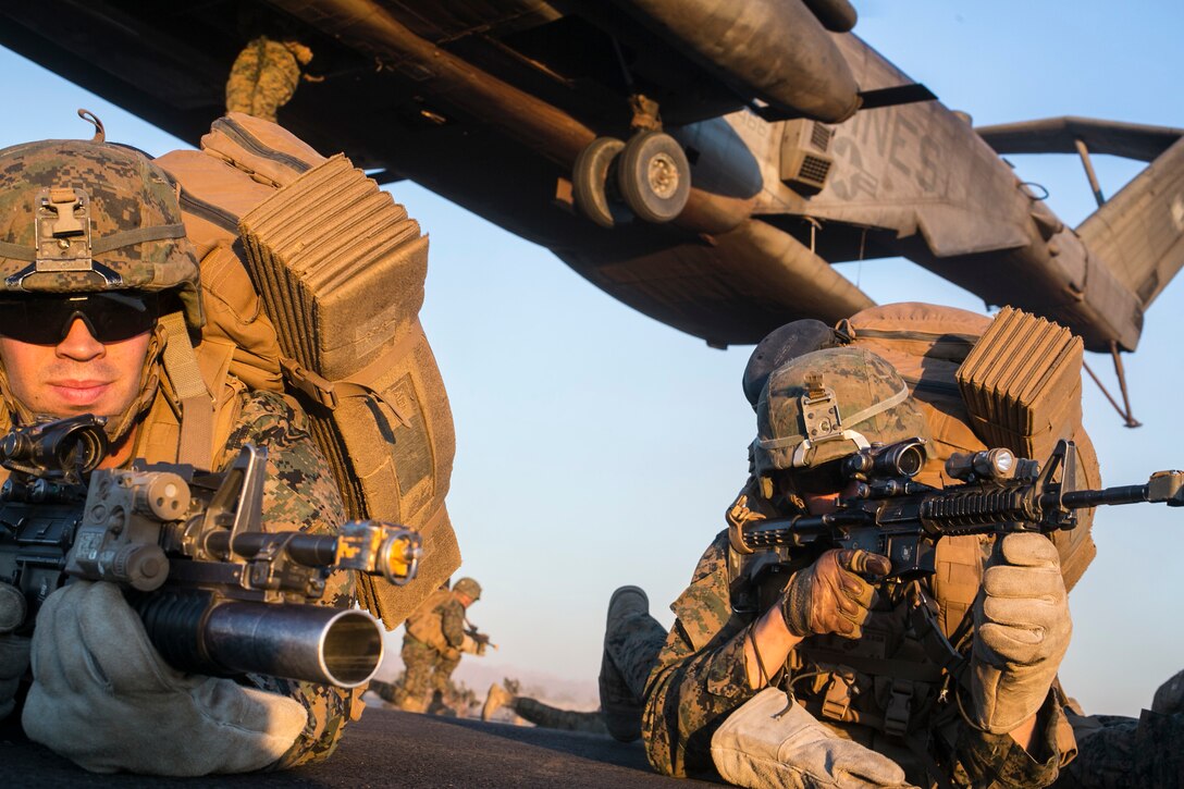 U.S. Marines attending the infantry officers course establish a perimeter during fast rope training in preparation for Talon Reach during Weapons and Tactics Instructor Course (WTI 2-15) at Auxiliary Airfield 2 near Yuma, AZ., March 26, 2015. WTI is a seven-week event hosted by Marine Aviation Weapons and Tactics Squadron One (MAWTS-1) cadre. MAWTS-1 provides standardized tactical training and certification of unit instructor qualifications to support Marine aviation Training and Readiness and assists in developing and employing aviation weapons and tactics. (U.S. Marine Corps photo by Lance Cpl. Jodson B. Graves 2d MAW Combat Camera/Released)