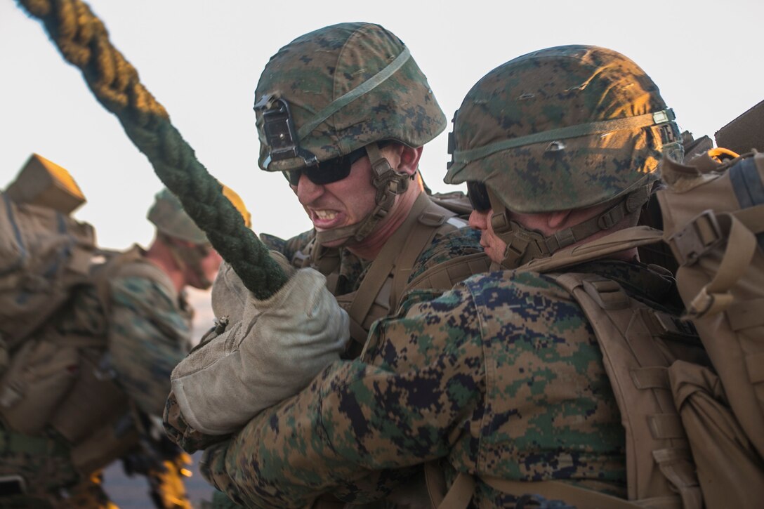 U.S. Marines attending the infantry officers course secure a rope during fast rope training in preparation for Talon Reach during Weapons and Tactics Instructor Course (WTI 2-15) at Auxiliary Airfield 2 near Yuma, AZ., March 26, 2015. WTI is a seven-week event hosted by Marine Aviation Weapons and Tactics Squadron One (MAWTS-1) cadre. MAWTS-1 provides standardized tactical training and certification of unit instructor qualifications to support Marine aviation Training and Readiness and assists in developing and employing aviation weapons and tactics. (U.S. Marine Corps photo by Lance Cpl. Jodson B. Graves 2d MAW Combat Camera/Released)