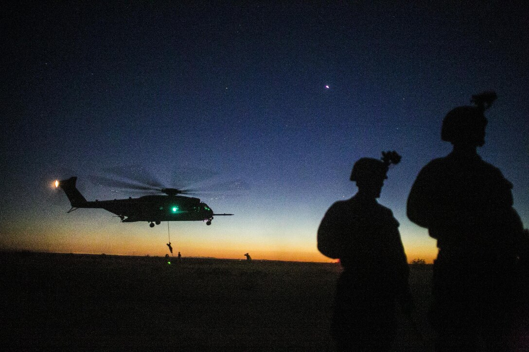 U.S. Marines attending the infantry officers course conduct fast rope training in preparation for Talon Reach during Weapons and Tactics Instructor Course (WTI 2-15) at Auxiliary Airfield 2 near Yuma, AZ., March 26, 2015. WTI is a seven-week event hosted by Marine Aviation Weapons and Tactics Squadron One (MAWTS-1) cadre. MAWTS-1 provides standardized tactical training and certification of unit instructor qualifications to support Marine aviation Training and Readiness and assists in developing and employing aviation weapons and tactics. (U.S. Marine Corps photo by Lance Cpl. Jodson B. Graves 2d MAW Combat Camera/Released)