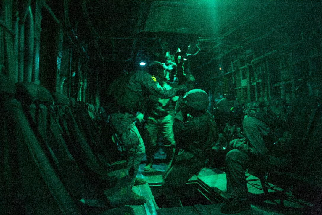 U.S. Marines attending the infantry officers course descend from a CH53E Super Stallion during fast rope training in preparation for Talon Reach during Weapons and Tactics Instructor Course (WTI 2-15) at Auxiliary Airfield 2 near Yuma, AZ., March 26, 2015. WTI is a seven-week event hosted by Marine Aviation Weapons and Tactics Squadron One (MAWTS-1) cadre. MAWTS-1 provides standardized tactical training and certification of unit instructor qualifications to support Marine aviation Training and Readiness and assists in developing and employing aviation weapons and tactics. (U.S. Marine Corps photo by Lance Cpl. Jodson B. Graves 2d MAW Combat Camera/Released)