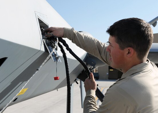 A 451st Expeditionary Aircraft Maintenance Squadron Airman performs preflight checks prior to launching an MQ-9 Reaper March 20, 2015, at Kandahar Airfield, Afghanistan. Airmen assigned to the 451st EAMXS provide 24/7 maintenance support to the Air Force’s largest Reaper unit, ensuring ground troops are supported around the clock. (U.S. Air Force photo/Staff Sgt. Whitney Amstutz)