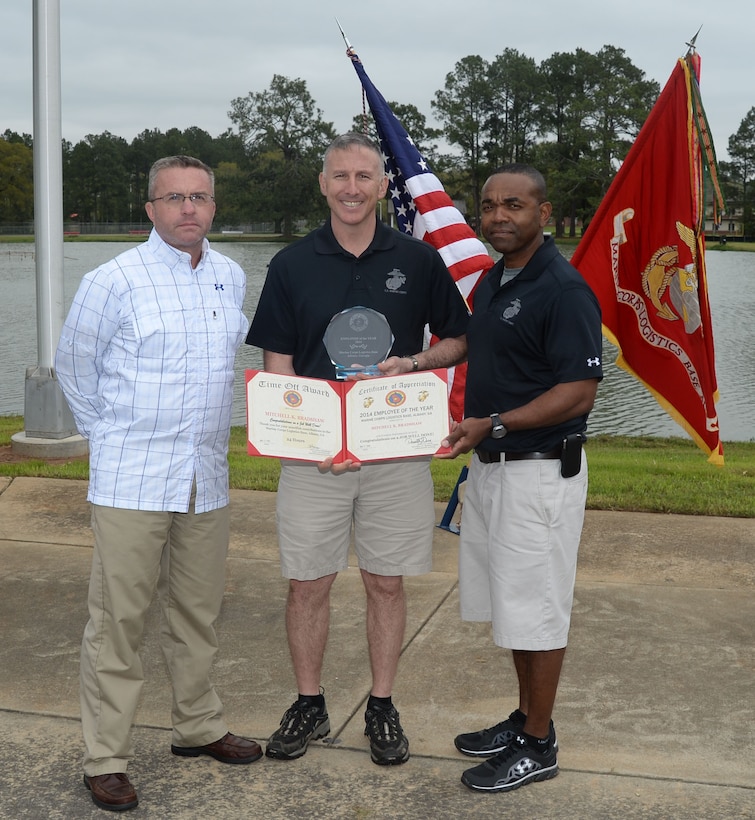 Mitchell Bradshaw, information technology specialist, Communications and Information Systems Division, Marine Corps Logistics Base Albany, receives the 2014 Employee of the Year Award at the annual Employee Recognition Day ceremony, March 27. Left: Todd Wilbanks, supervisory information technology specialist, CISD, MCLB Albany, accepted on Bradshaw’s behalf at the event, which was held, here, at Boyett Park.
